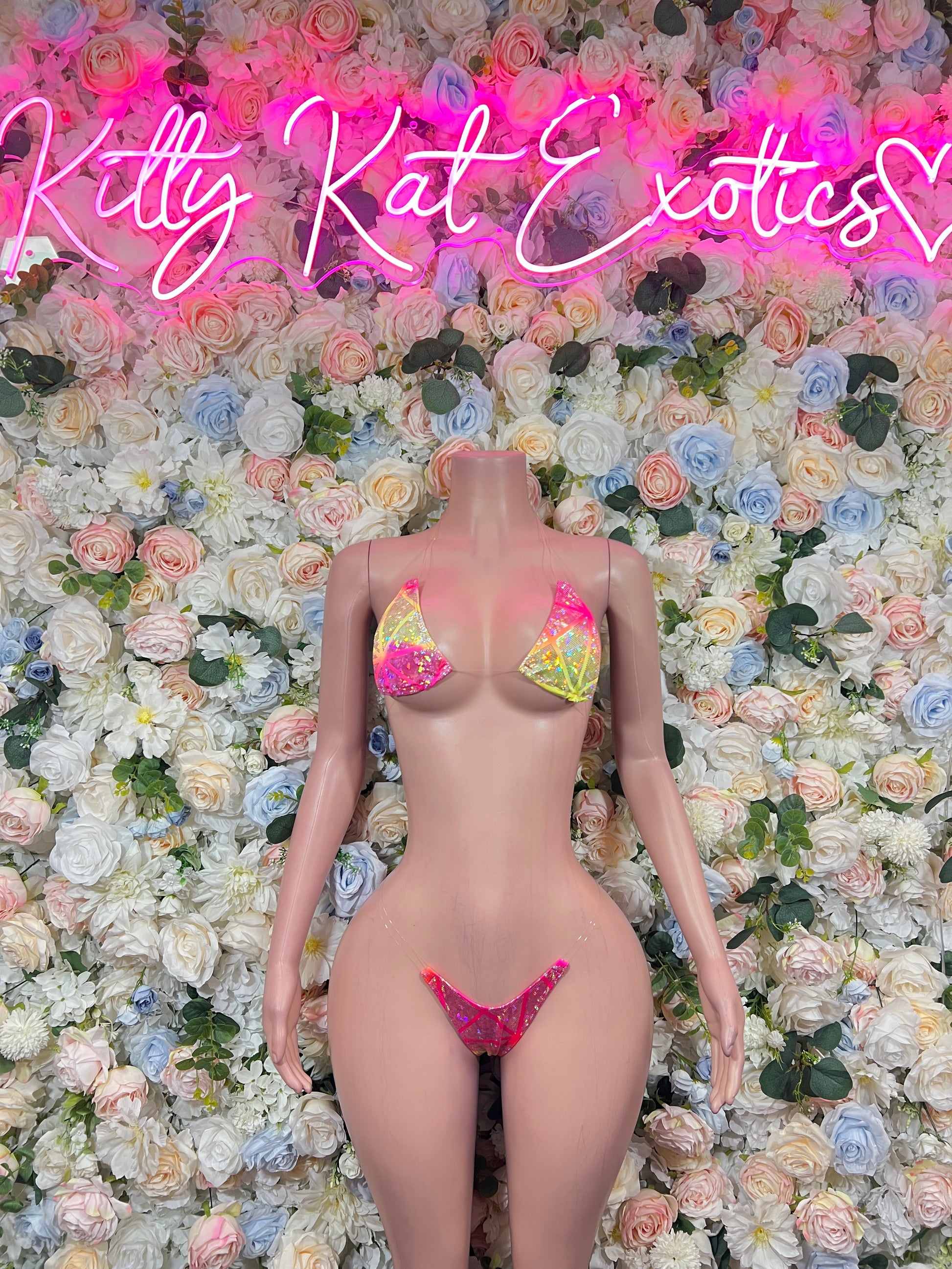 Pink triangle bikini with yellow print accents, front view on mannequin