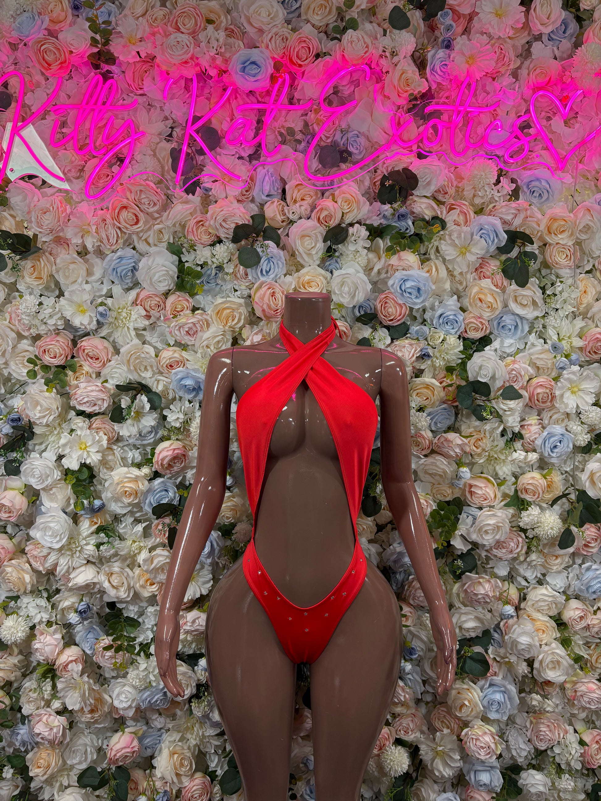 Red halter bodysuit with crisscross chest and high-cut legs