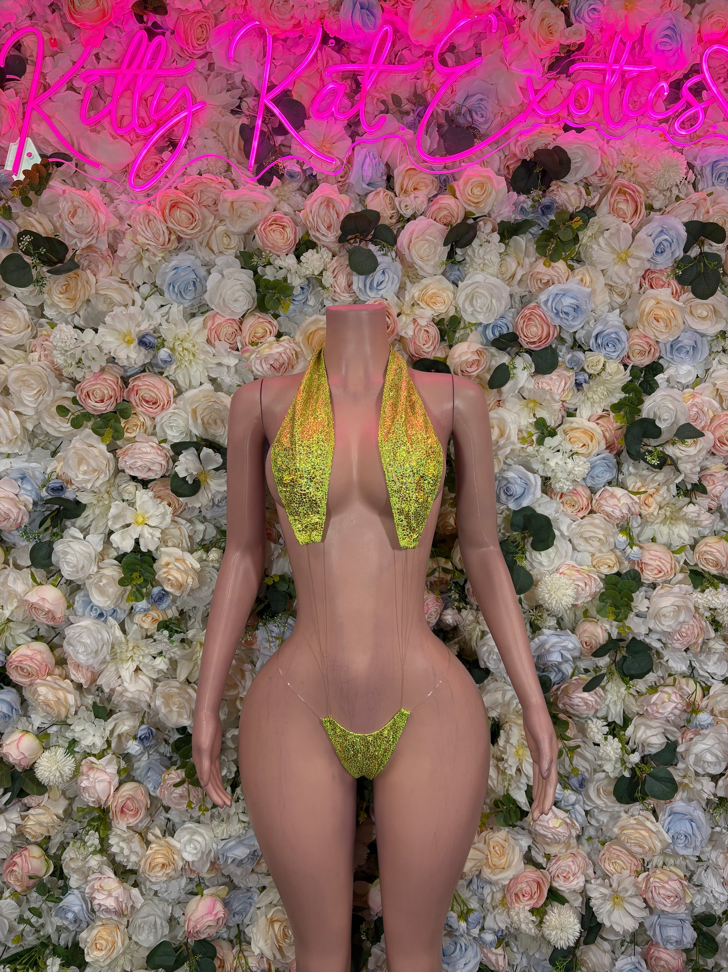 Neon green glitter slingshot bodysuit with triangular front cutout and narrow straps