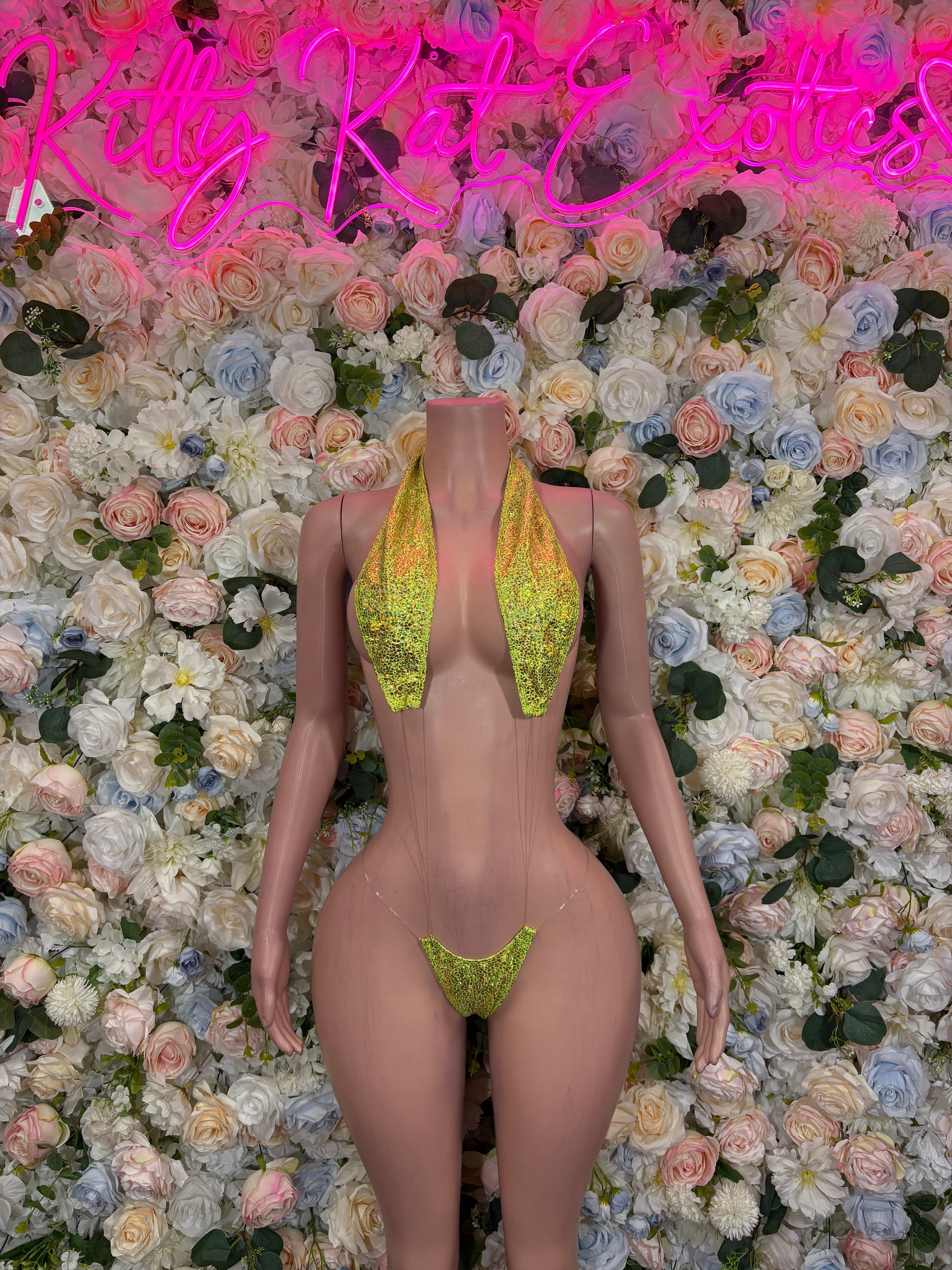 Neon green glitter slingshot bodysuit with triangular front cutout and narrow straps
