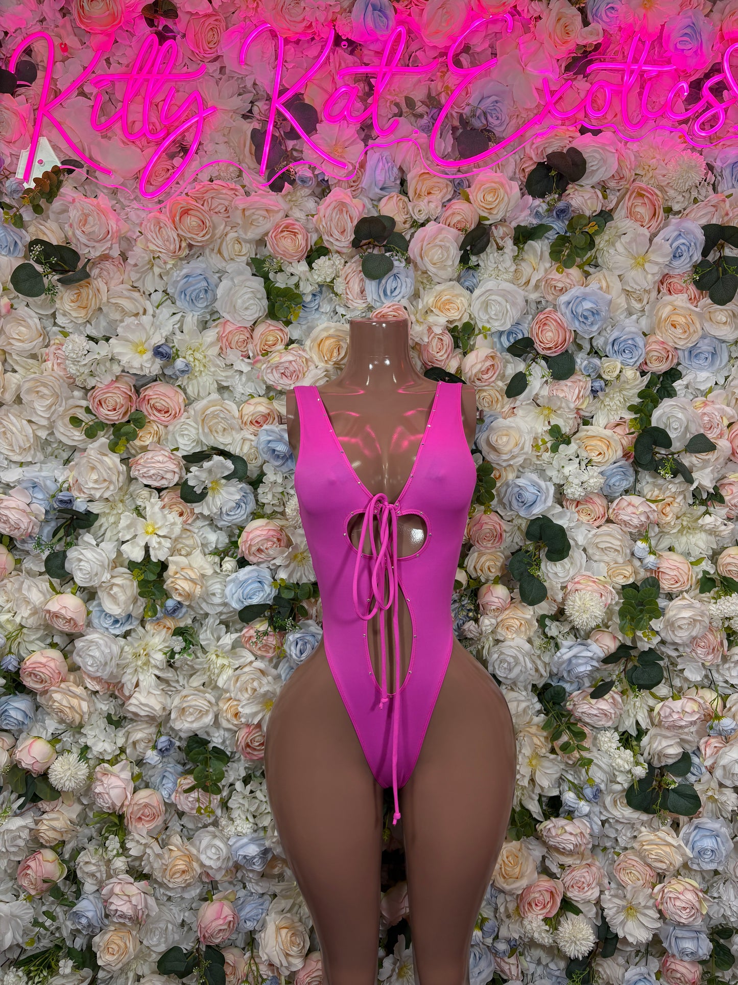 Hot pink one-piece rave swimsuit with lace-up tie front and high-cut leg openings