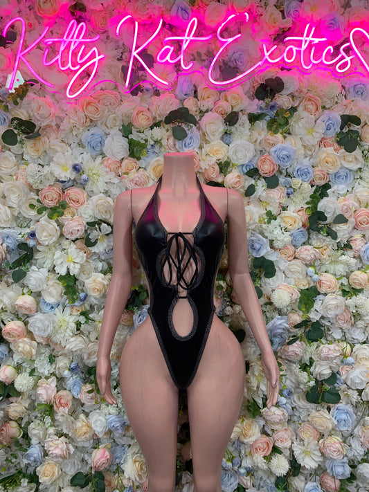 Black latex one-piece bodysuit with lace-up oval cutout front and high-cut leg