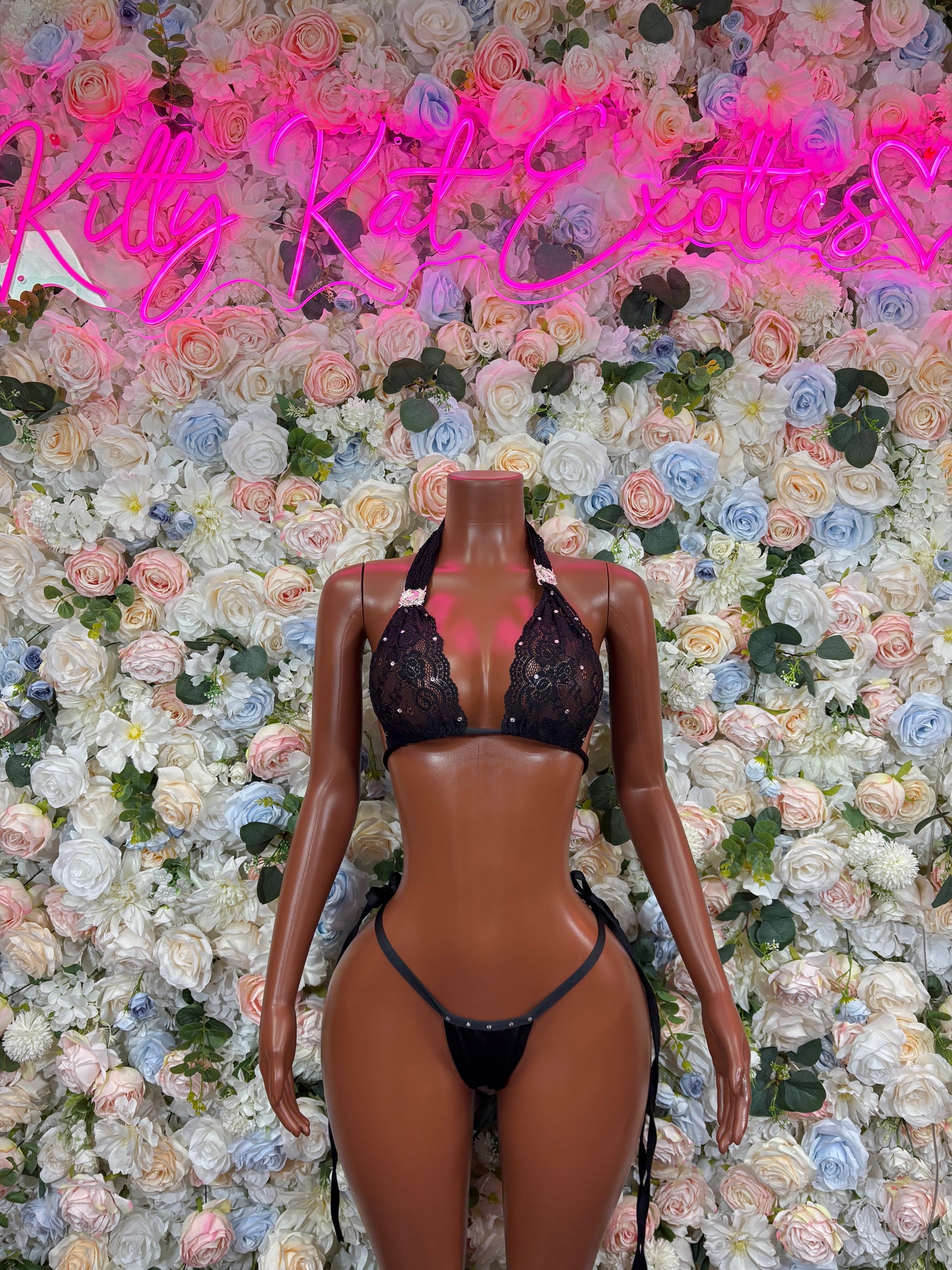 Black lace bikini top with tie-back bottom on mannequin