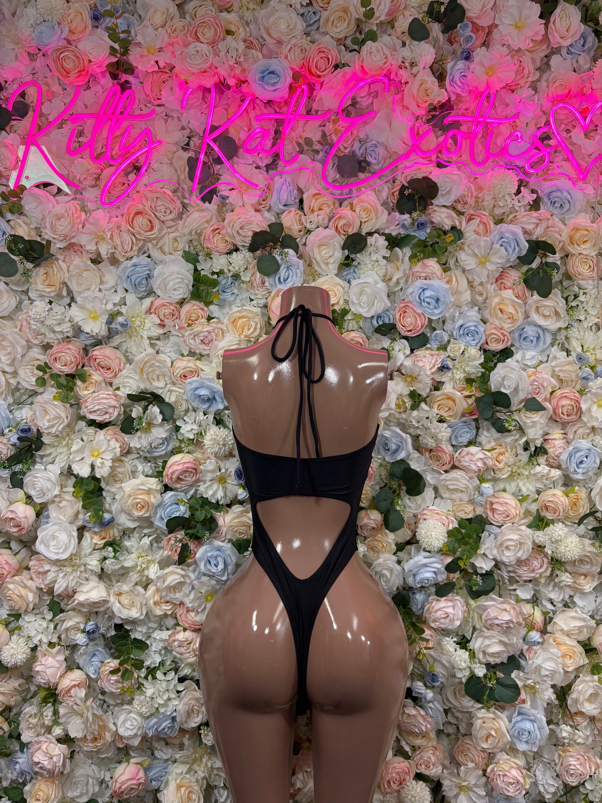 Black sheer backless bodysuit with tied straps and heart-shaped cutout