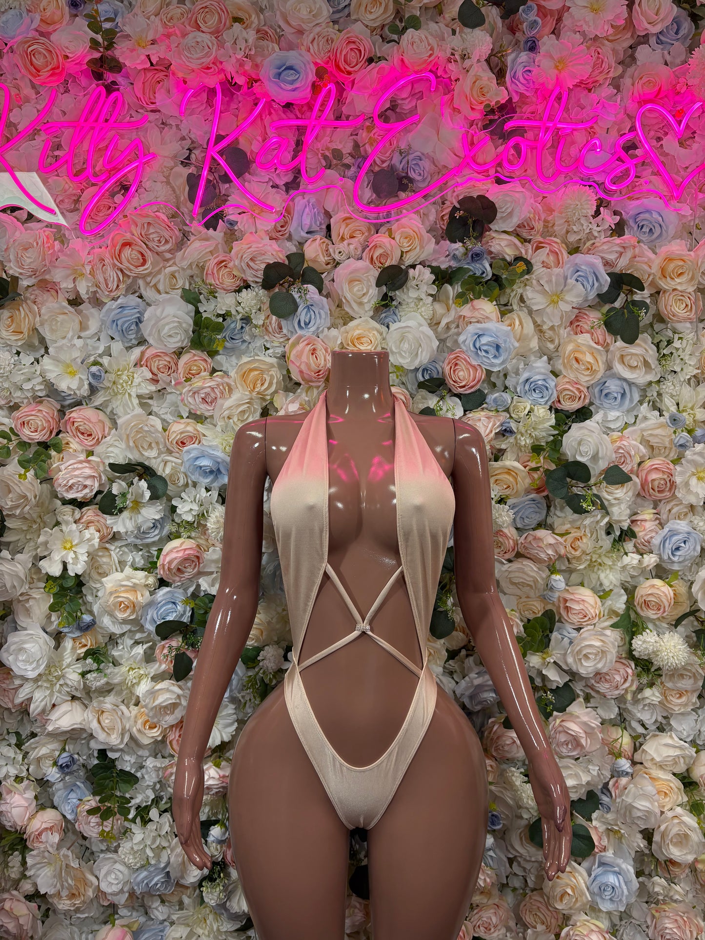 Nude one-piece bodysuit with halter neckline and crisscross front straps