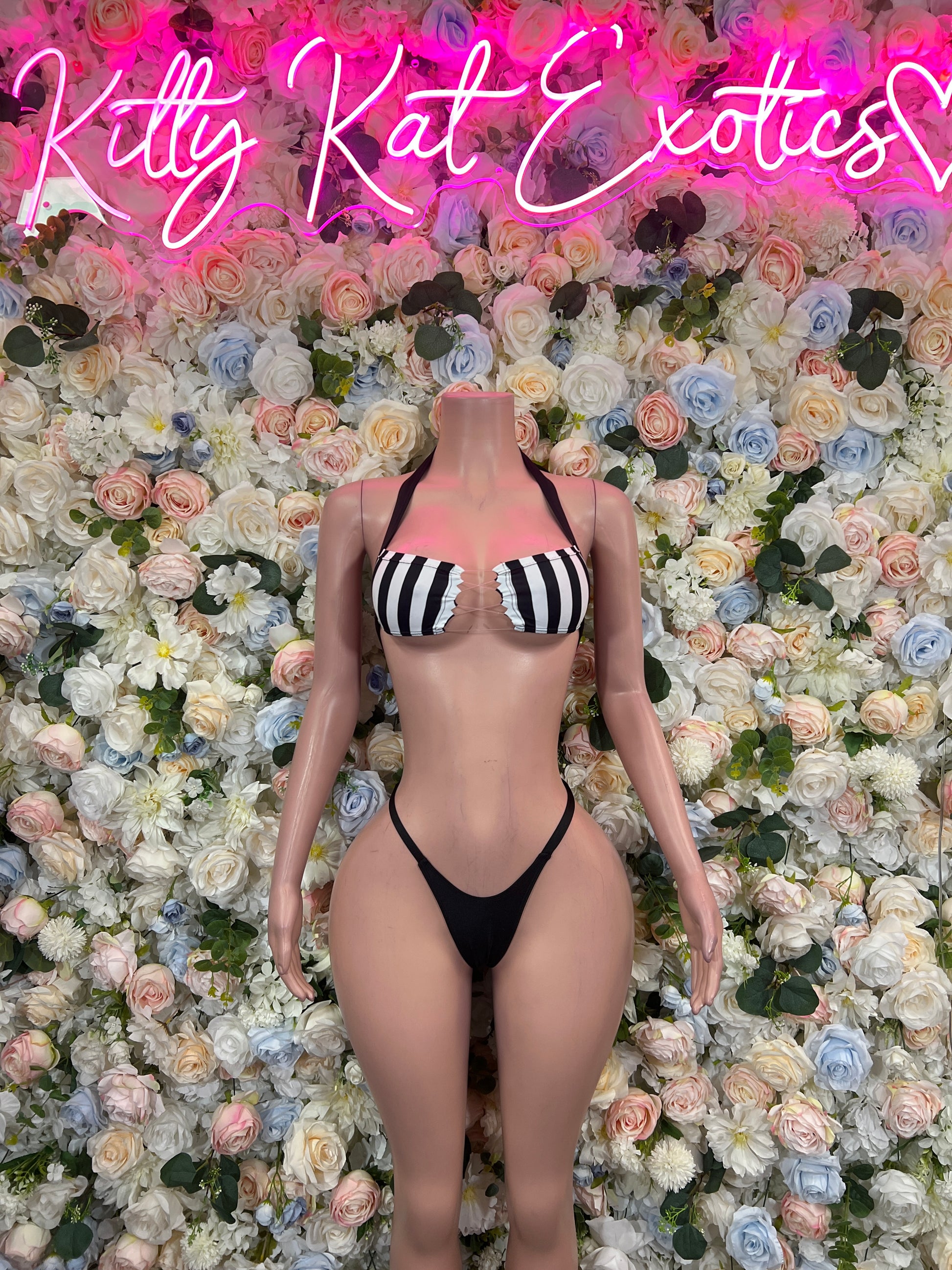 Front view of black-and-white striped bikini with halter-style top and thong bottoms