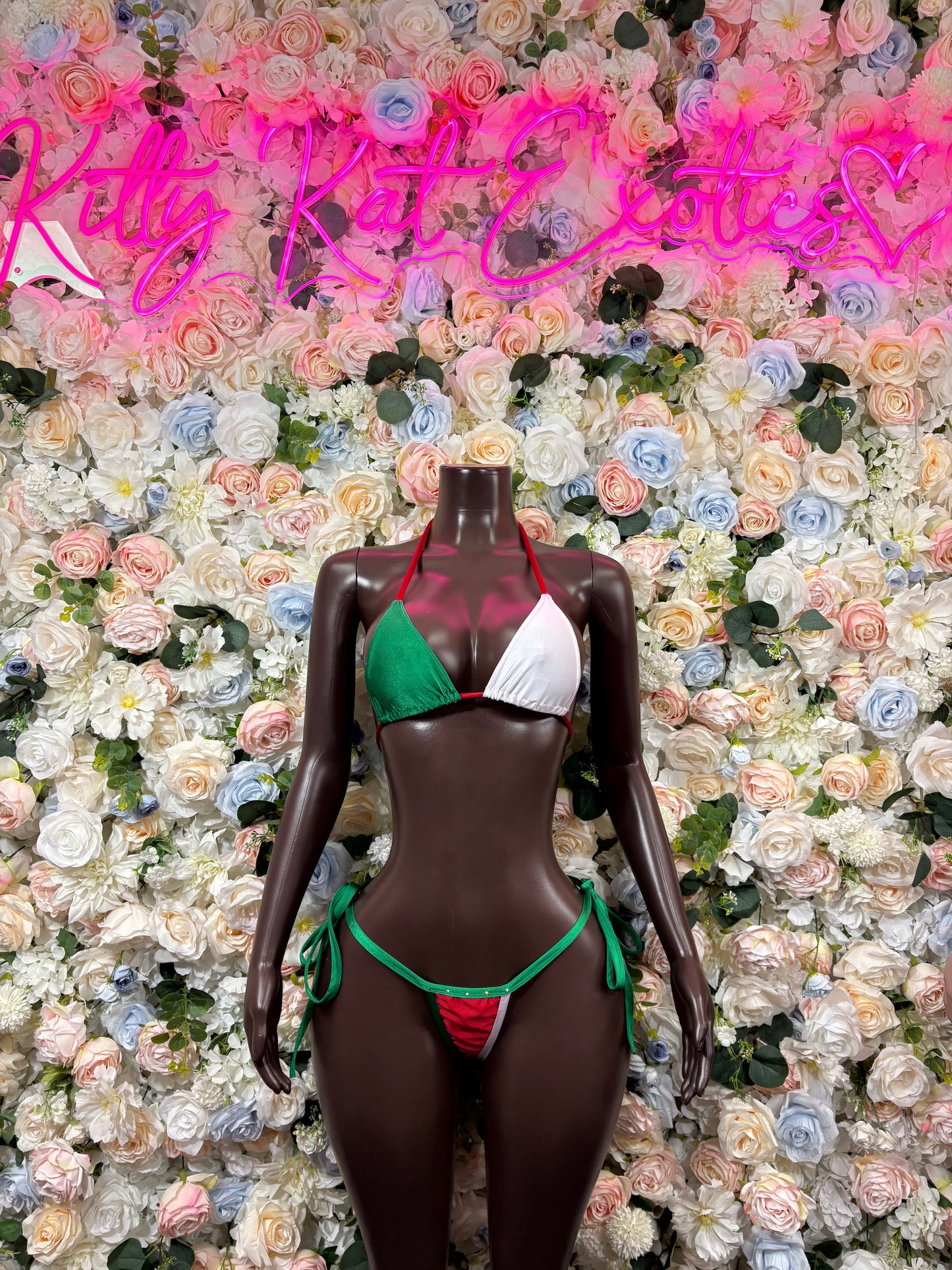 Green and white triangle bikini set with string bottoms, front view.