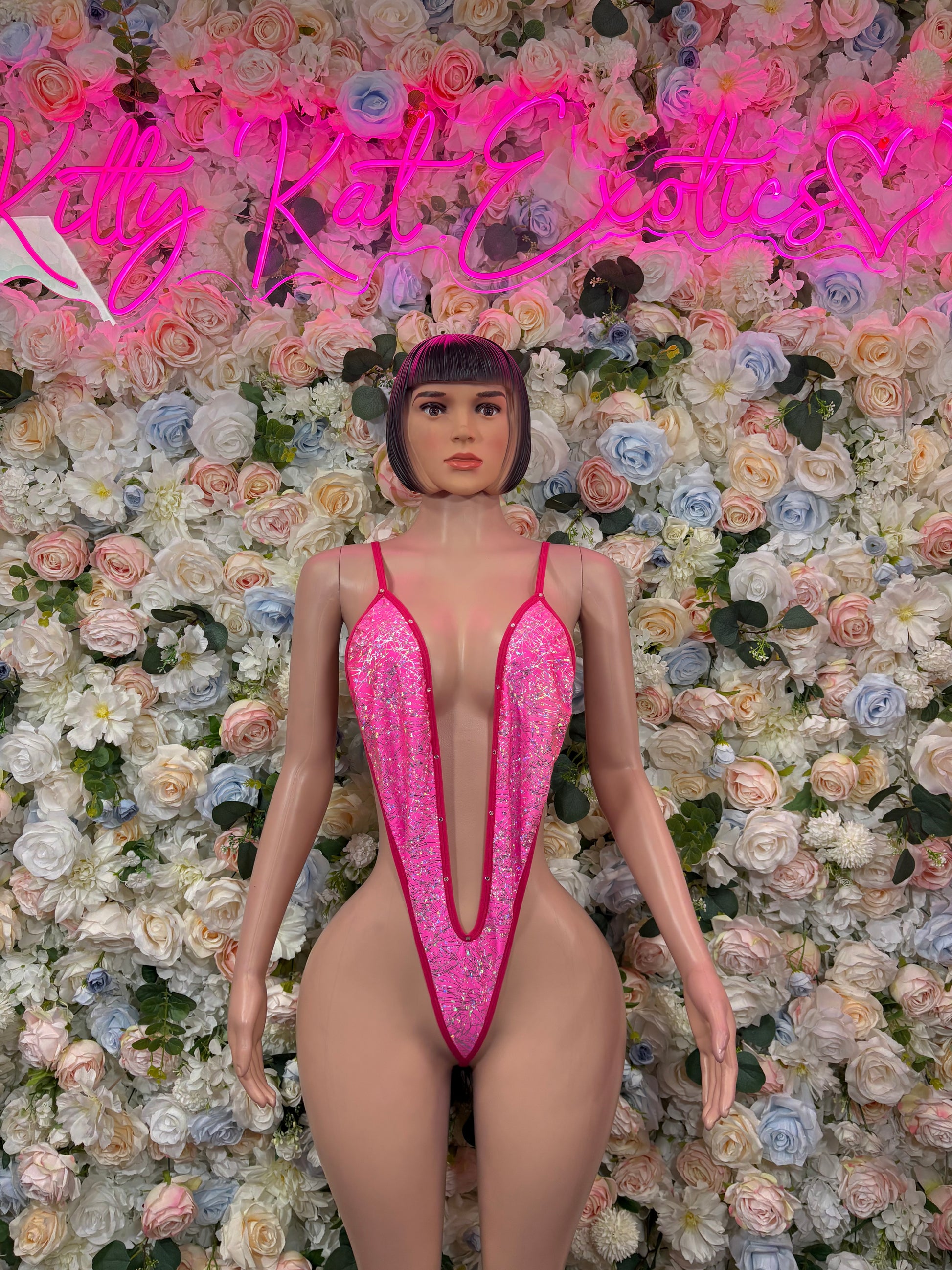 Pink glitter one-piece bodysuit with V neckline and thin spaghetti straps