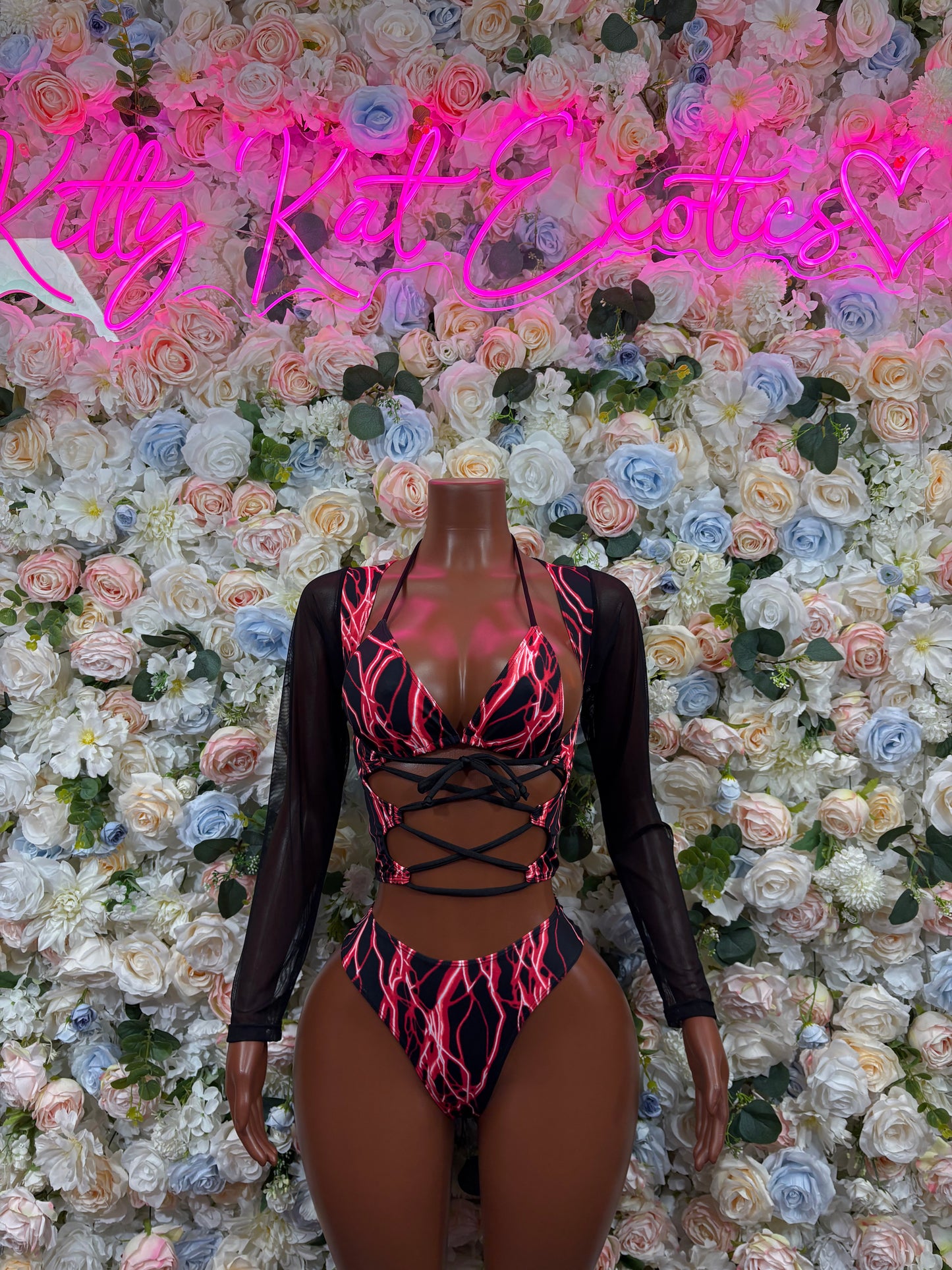 Red electric one-piece bodysuit, black long sleeves, crisscross lace-up front