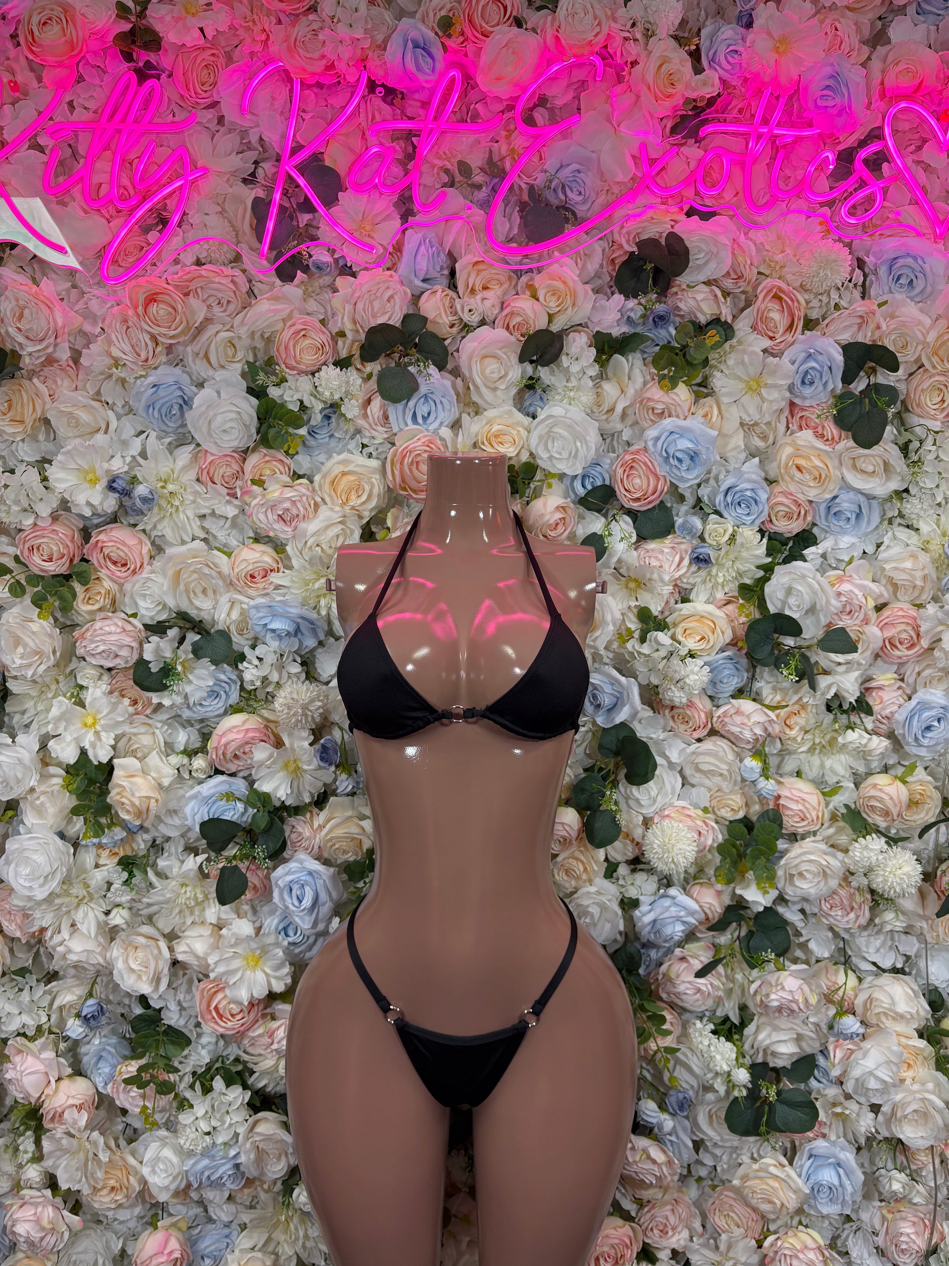 Black lace bodysuit front with triangle cups, thin straps, and high-cut thong bottom