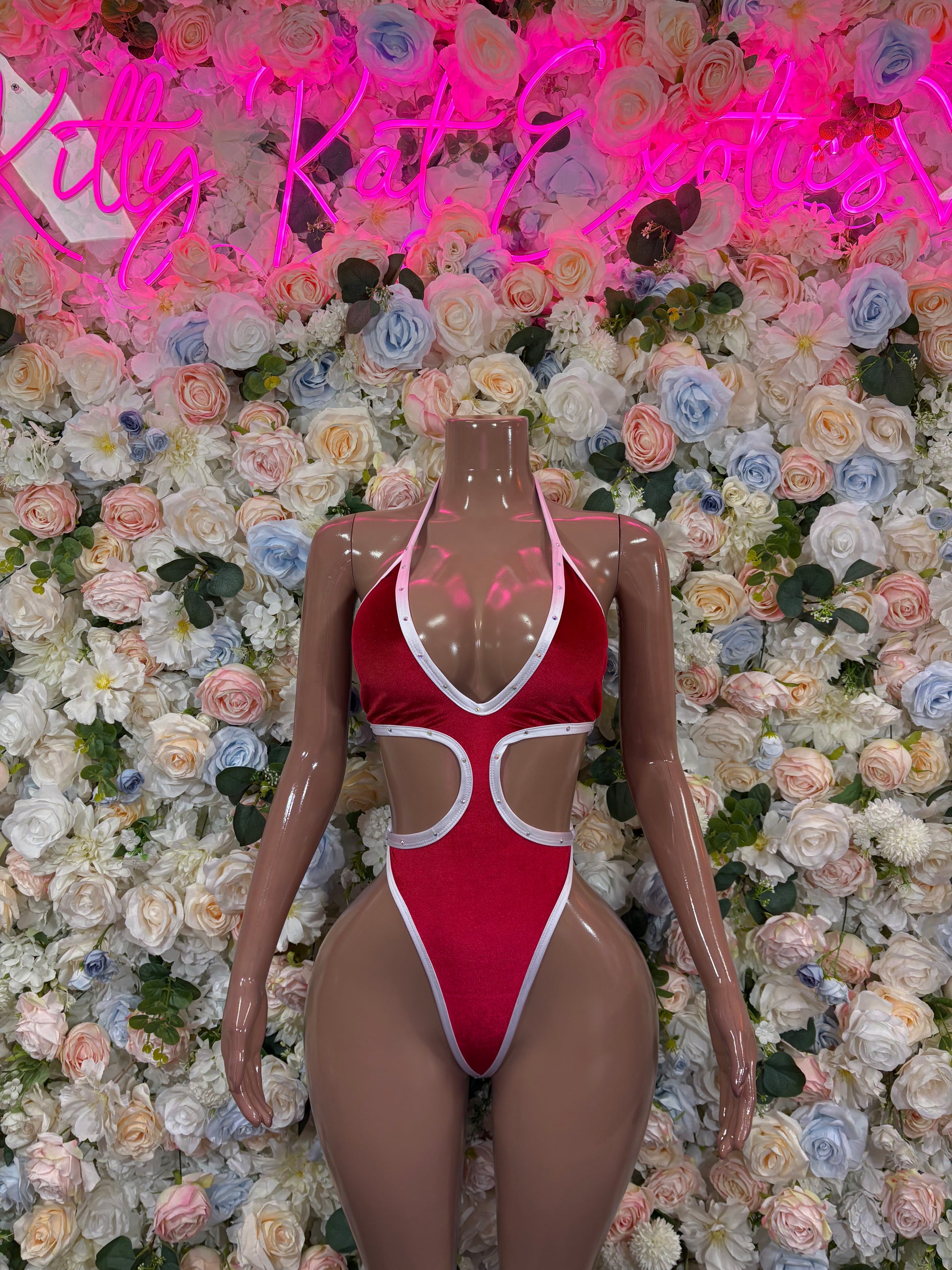 Red Santa-style one-piece bodysuit with white trim and lace-back