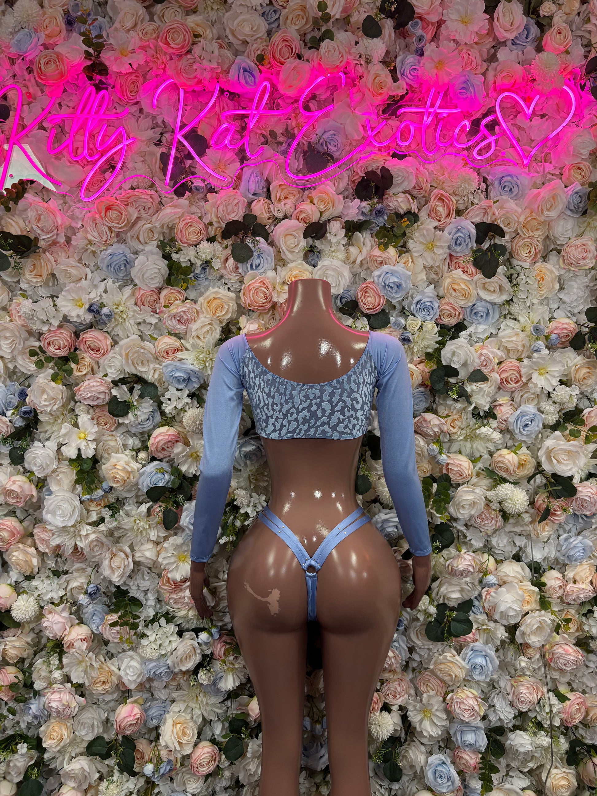 Light blue lace-front two-piece rave outfit with long sleeves, front view on mannequin