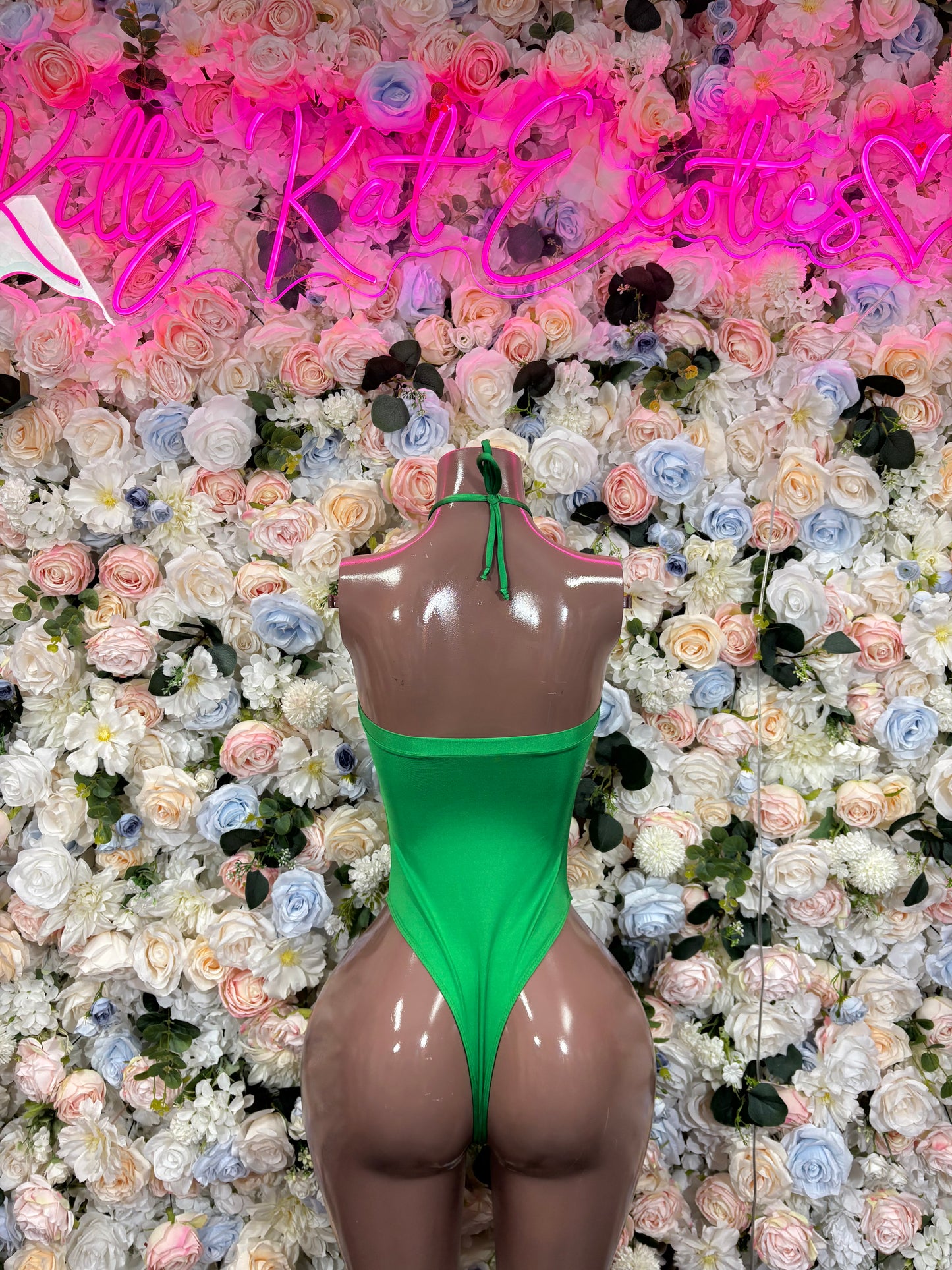 Green halter bodysuit with lace-up neckline and high-cut thong back