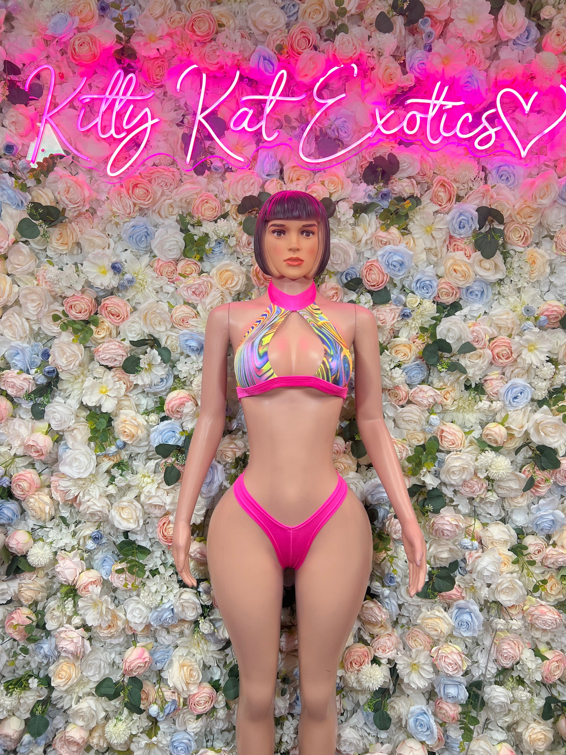 Front view of multicolor halter bikini top with pink trim and matching two-piece bottoms