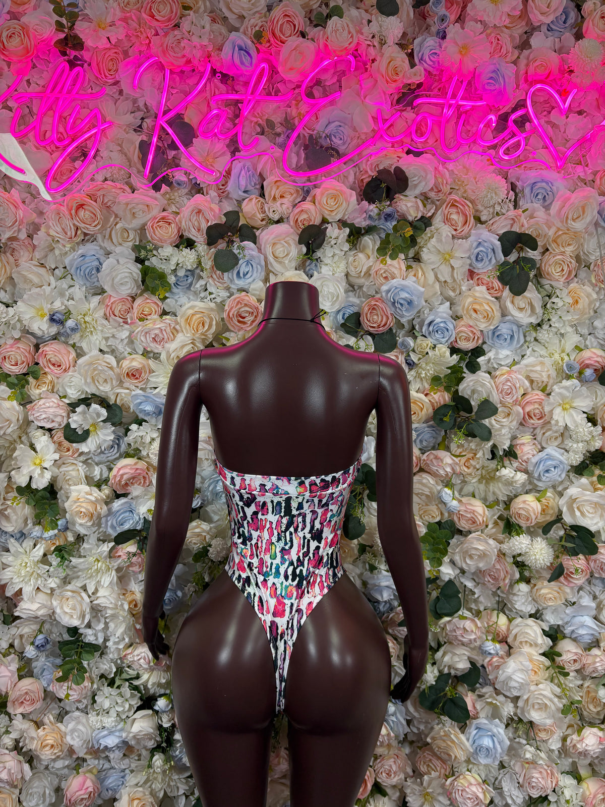 Multicolor one-piece bodysuit with V-neck, thin straps, and high-cut leg openings