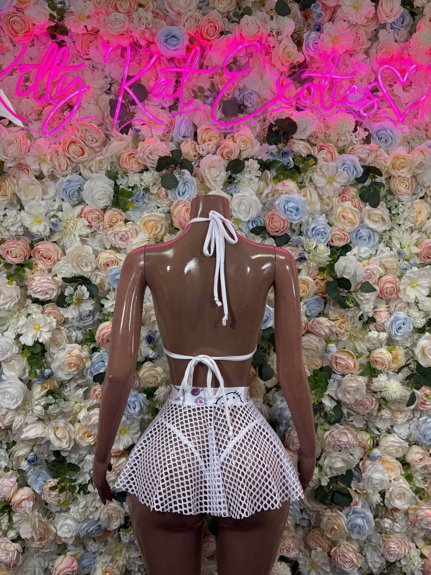Kitty print skirt set back view: halter bikini with tied straps and mesh flared mini skirt