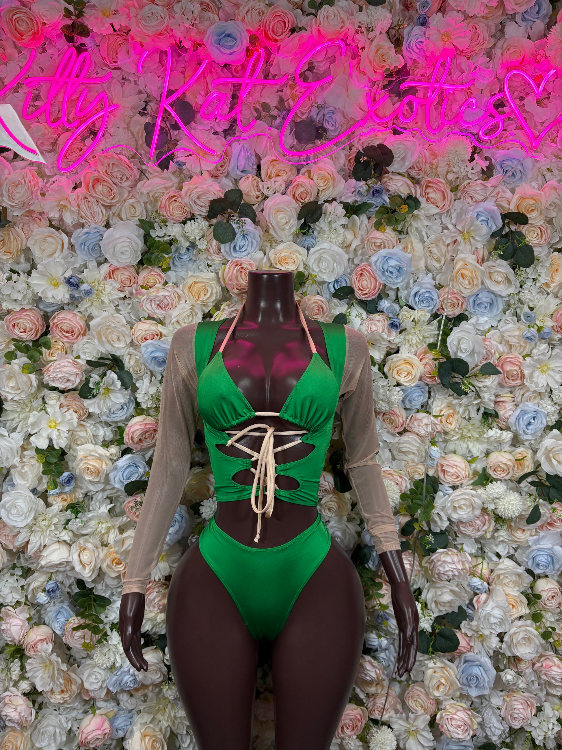 Green lace-up bodysuit with long sheer sleeves and halter neckline
