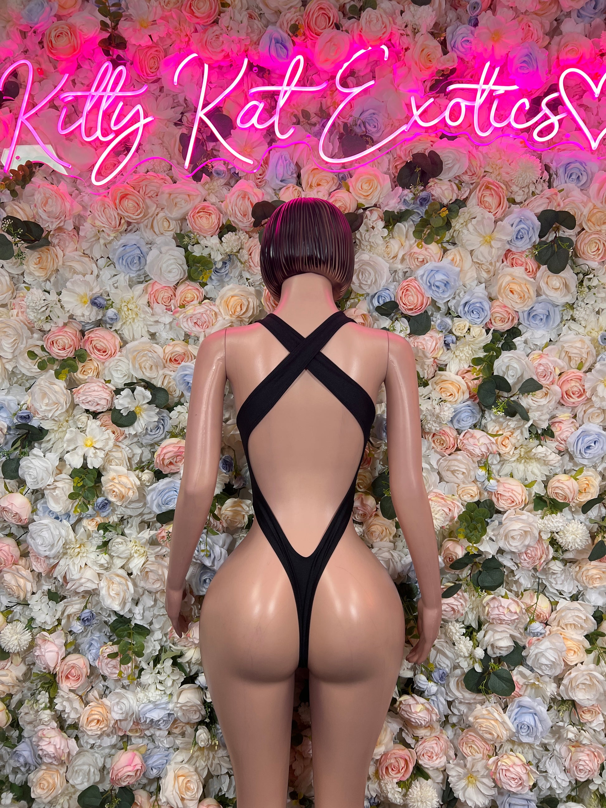Black halter bodysuit with open back and crisscross straps
