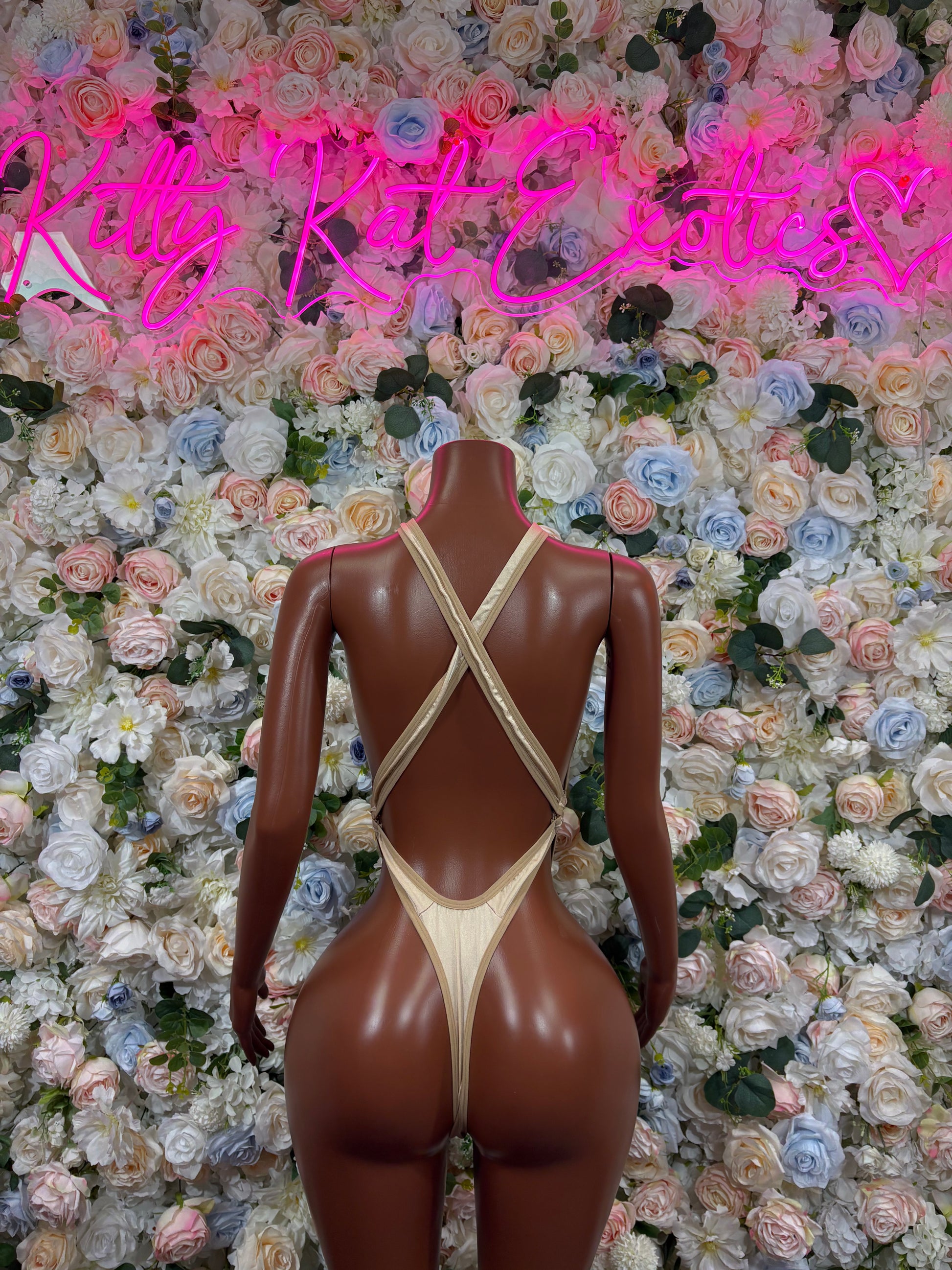 Cream sheer one-piece bodysuit with crisscross back straps and thong cut