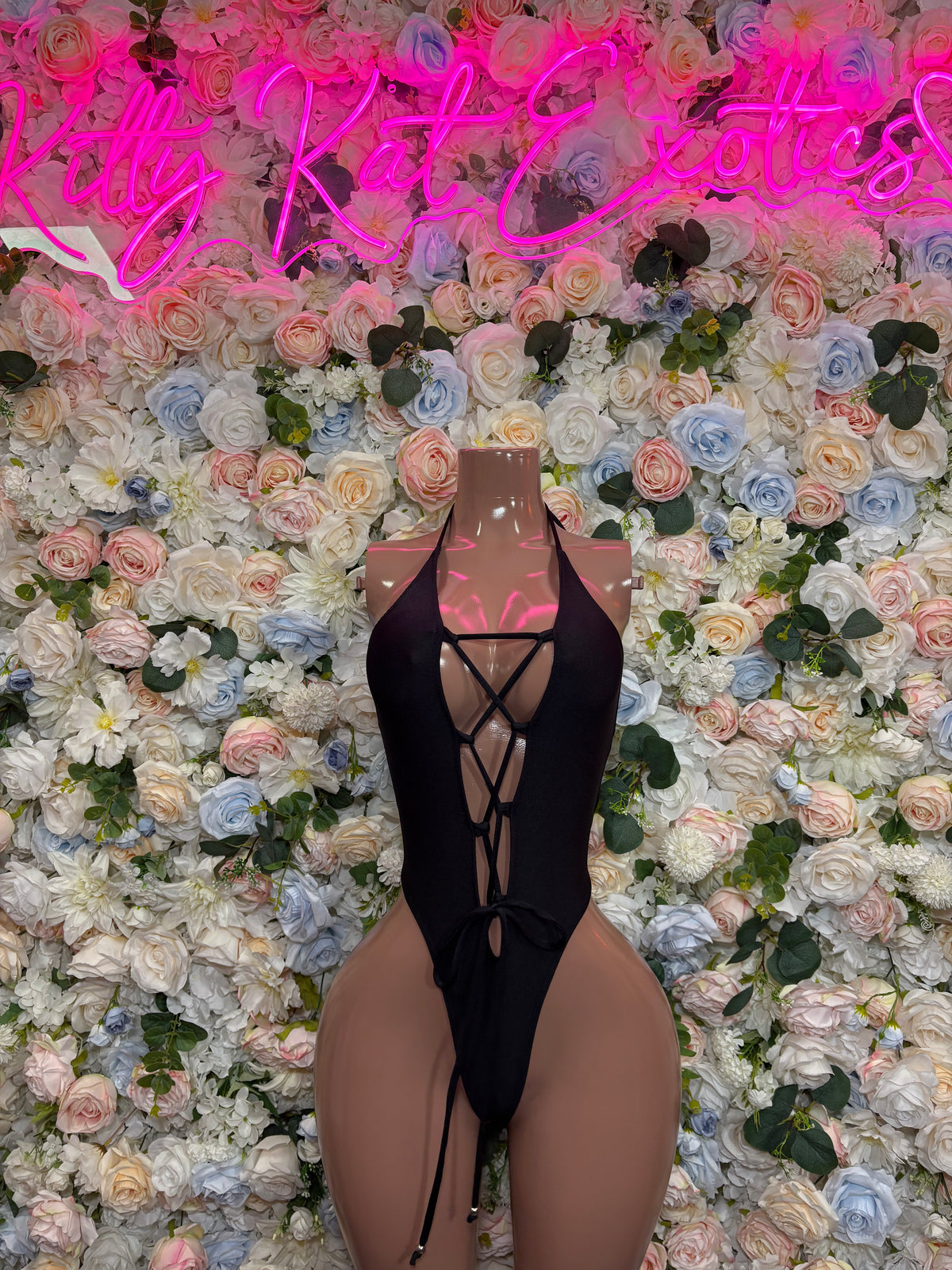 Black lace-up rave bodysuit with crisscross front straps and cutout one-piece