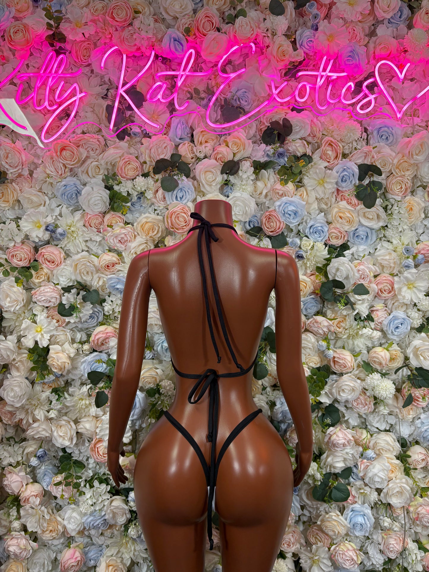Back view of black and white striped halter bikini with tied crisscross straps