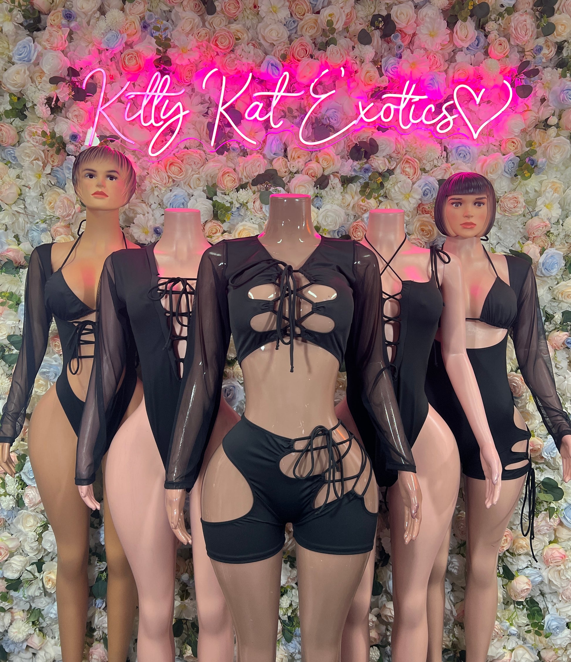 Black bodysuit with sheer long sleeves, deep V front, lace-up cutouts