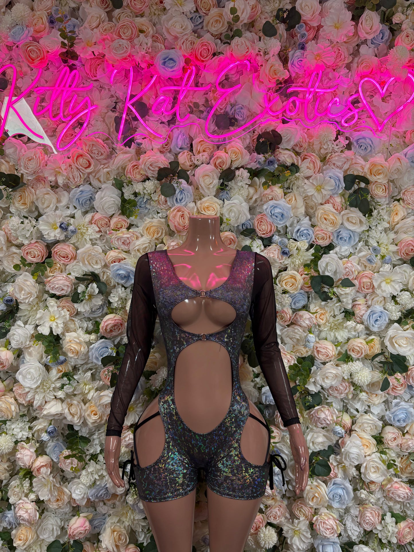Black metallic sheer long-sleeve bodysuit with oval chest cutout and hip straps