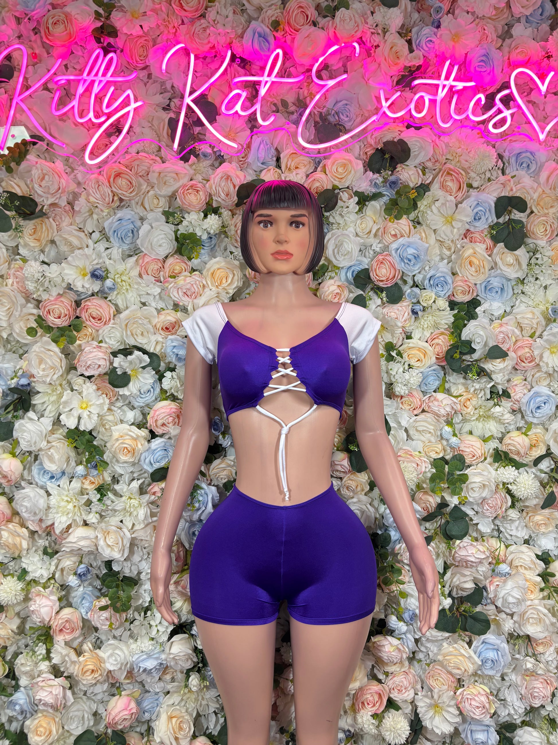 Purple short bodysuit with white lace-up V-front and puff sleeves
