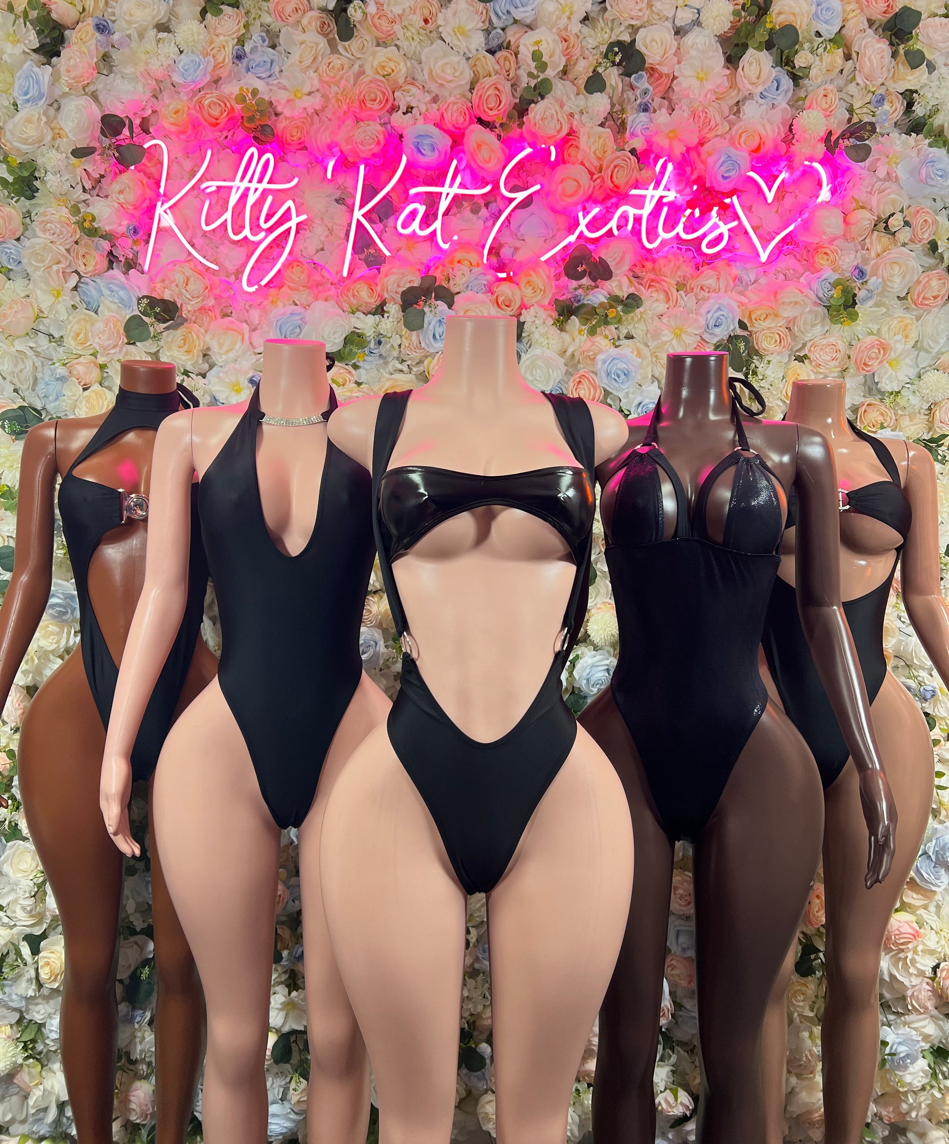 Black one-piece bodysuits with plunging necklines and back strap detailing