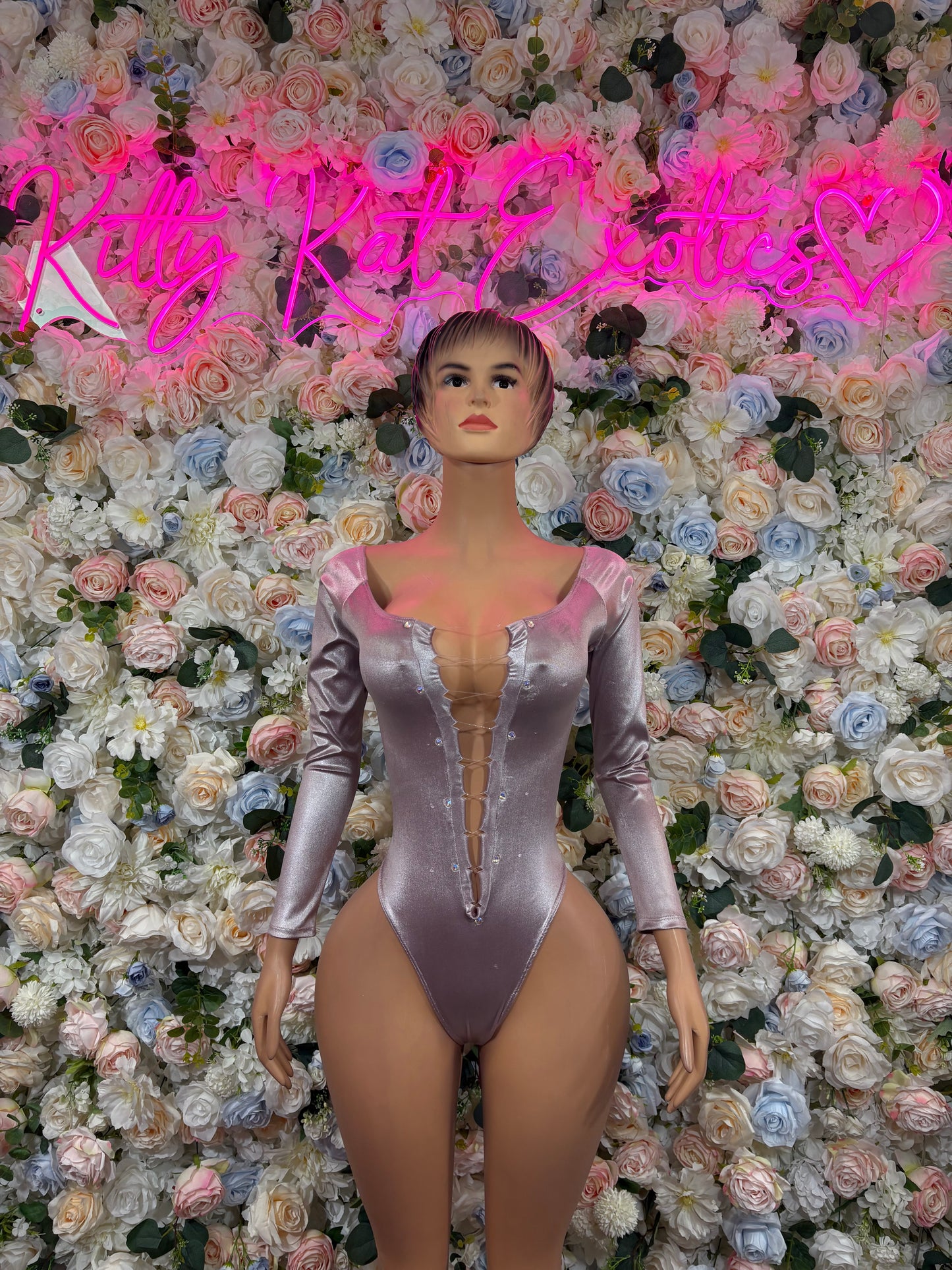 Metallic silver one-piece bodysuit with long sleeves and deep V neckline