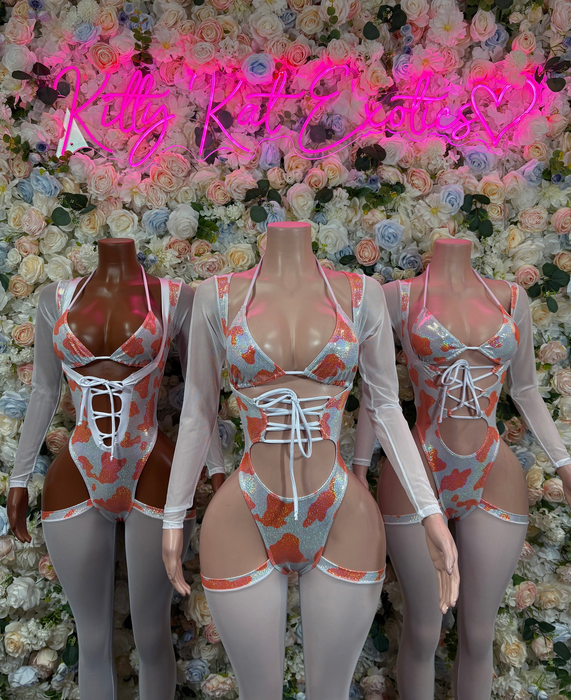 Orange cow print long-sleeve bodysuit with corset-style lace-up front and garter straps