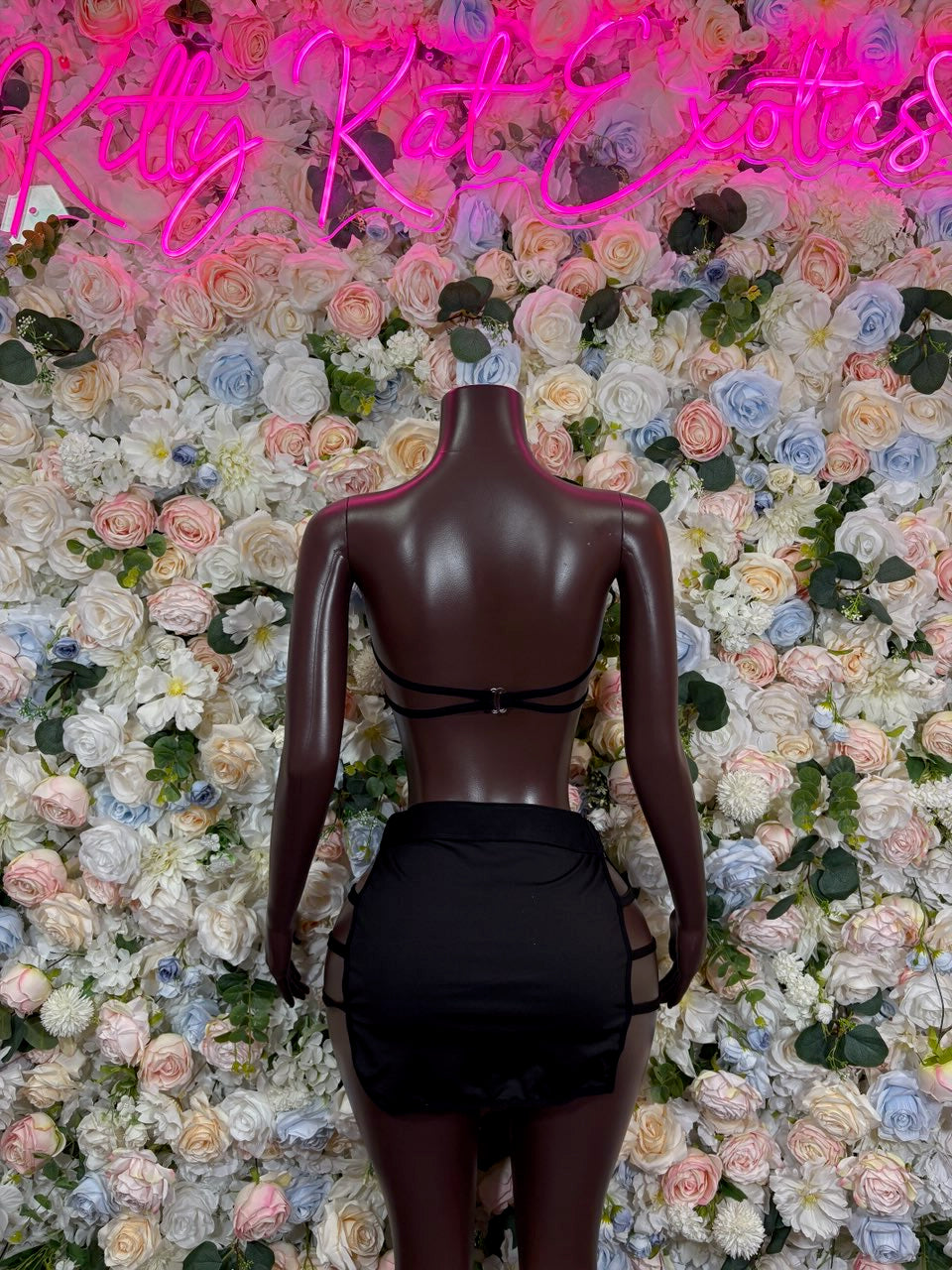 Burgundy metallic halter crop top and mini skirt two-piece set on mannequin