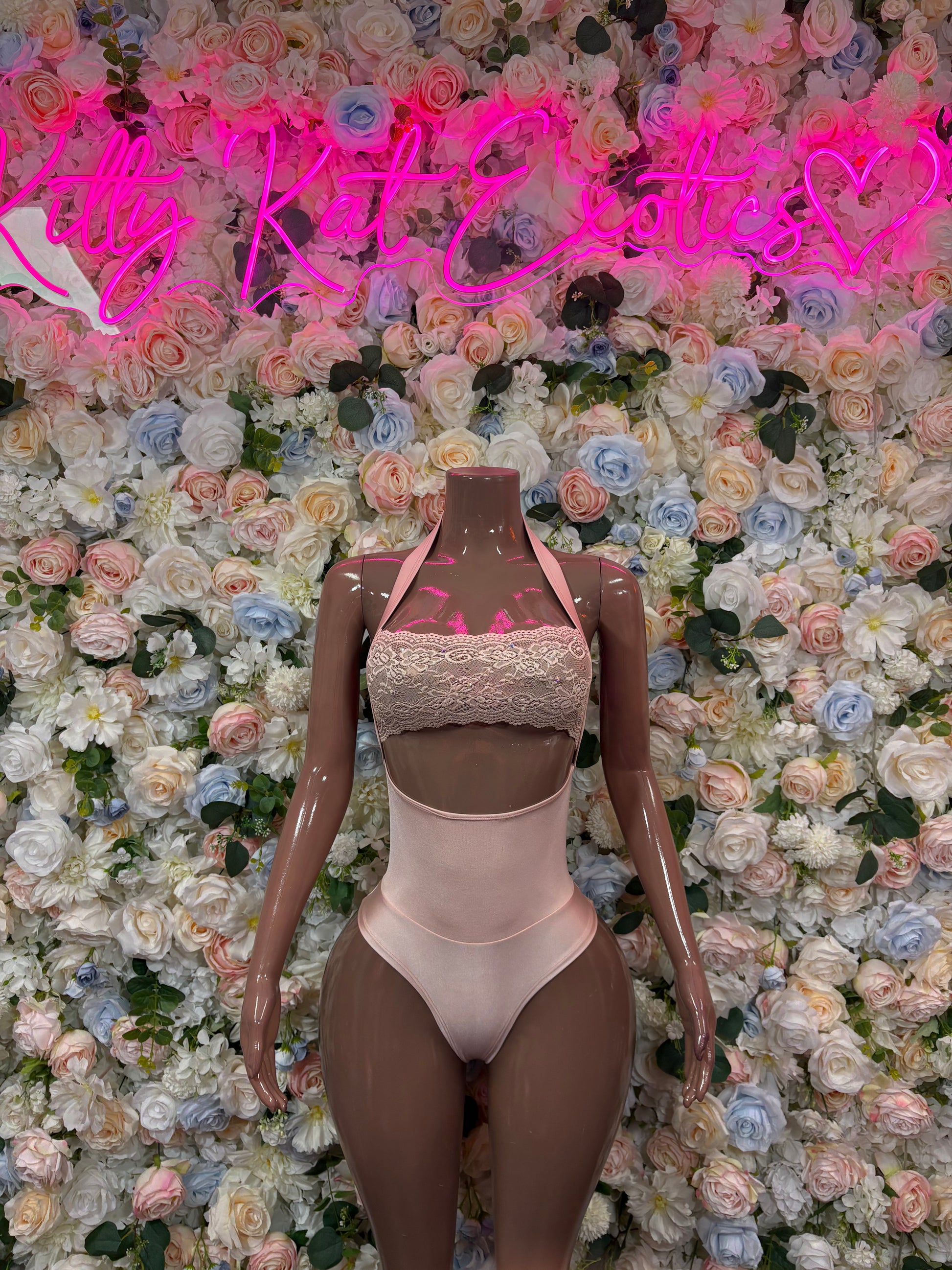 Nude bodysuit with high neck, cheeky cutouts, and open back straps