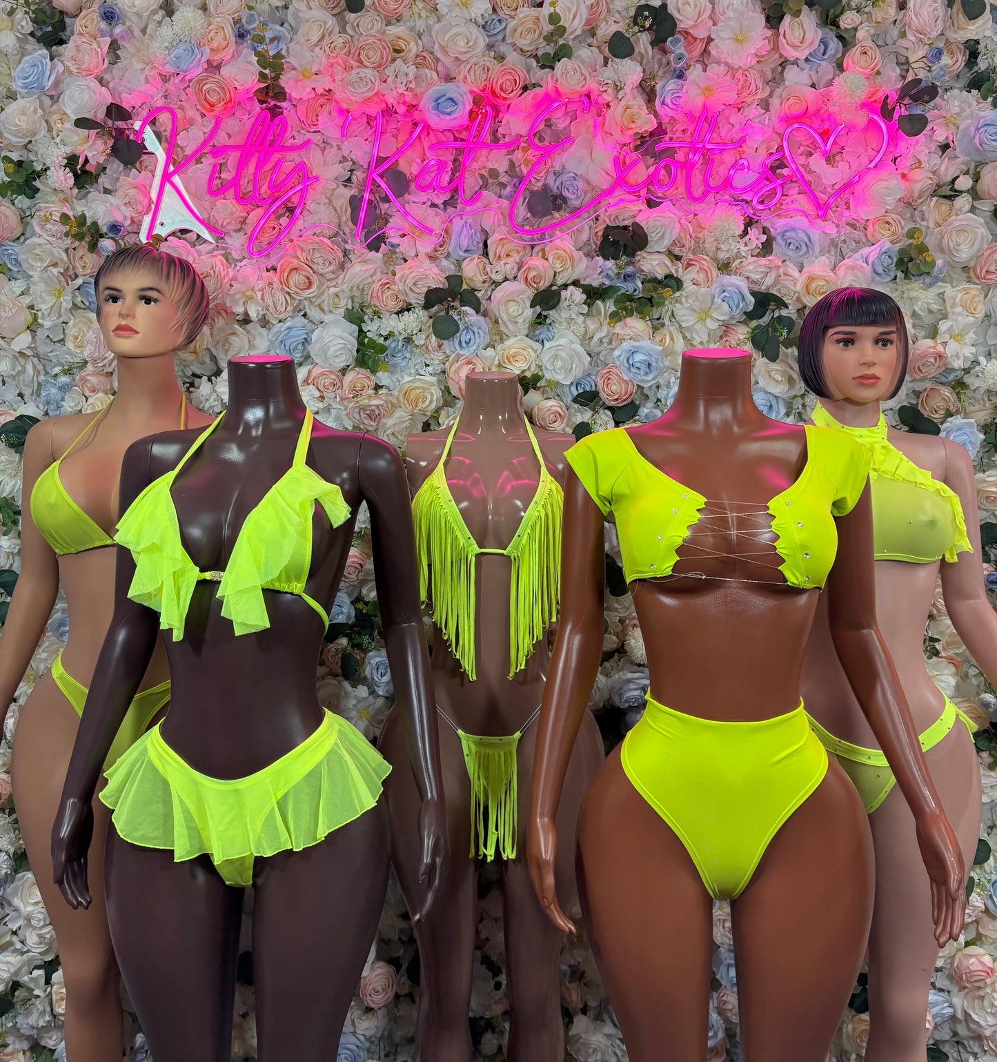 Neon green two-piece ravewear set on mannequins: fringe bra and bikini bottoms