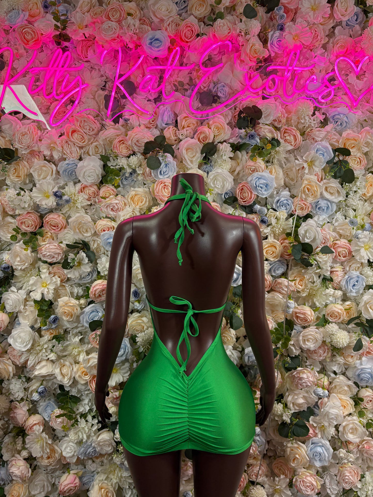 Green open-back festival bodysuit dress with tie straps and tassel fringe