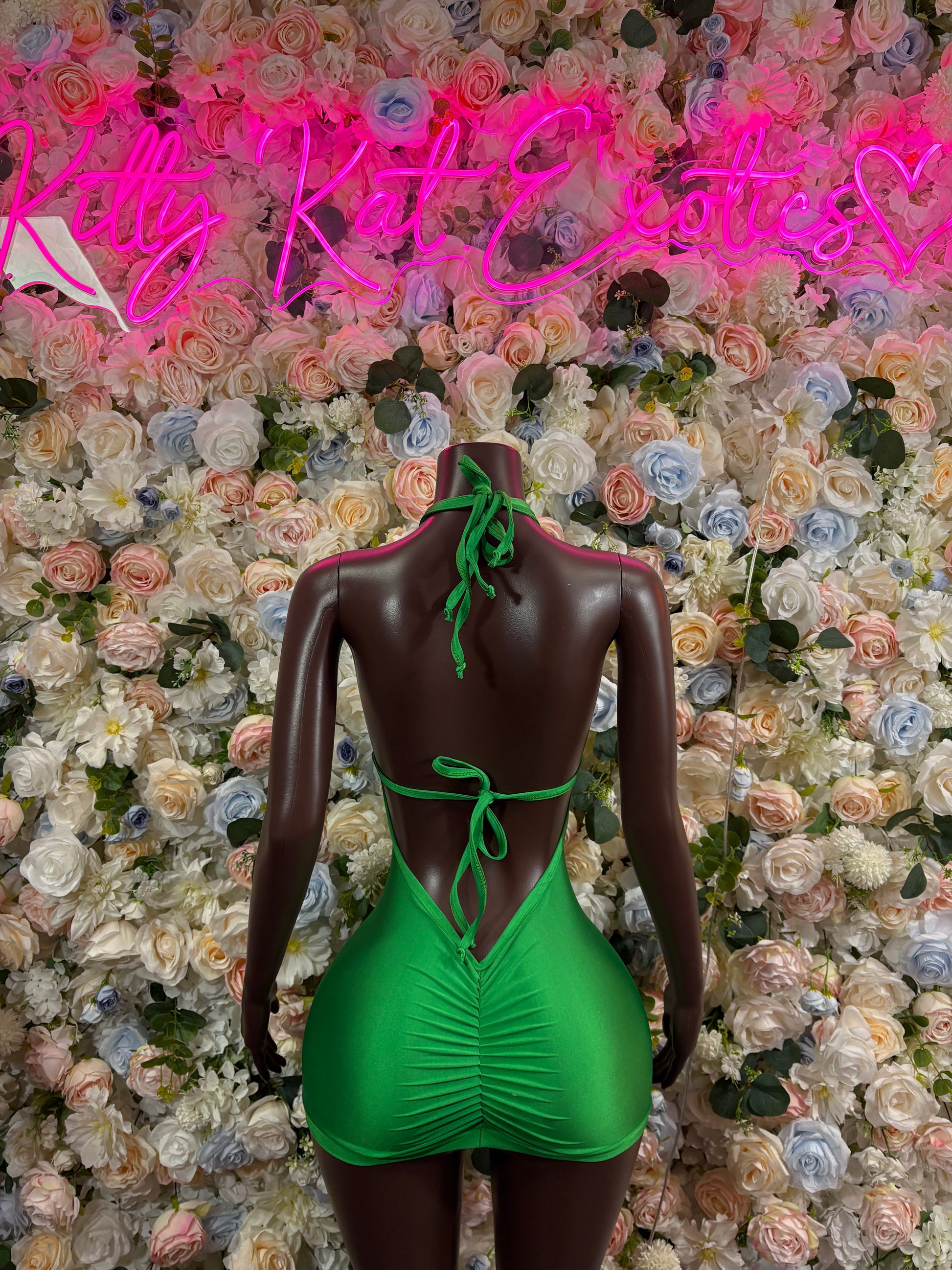 Green open-back festival bodysuit dress with tie straps and tassel fringe