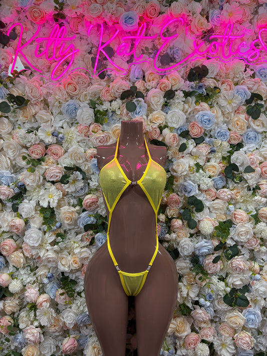 Yellow metallic bodysuit with halter straps and cutout waist, high-cut bottom.