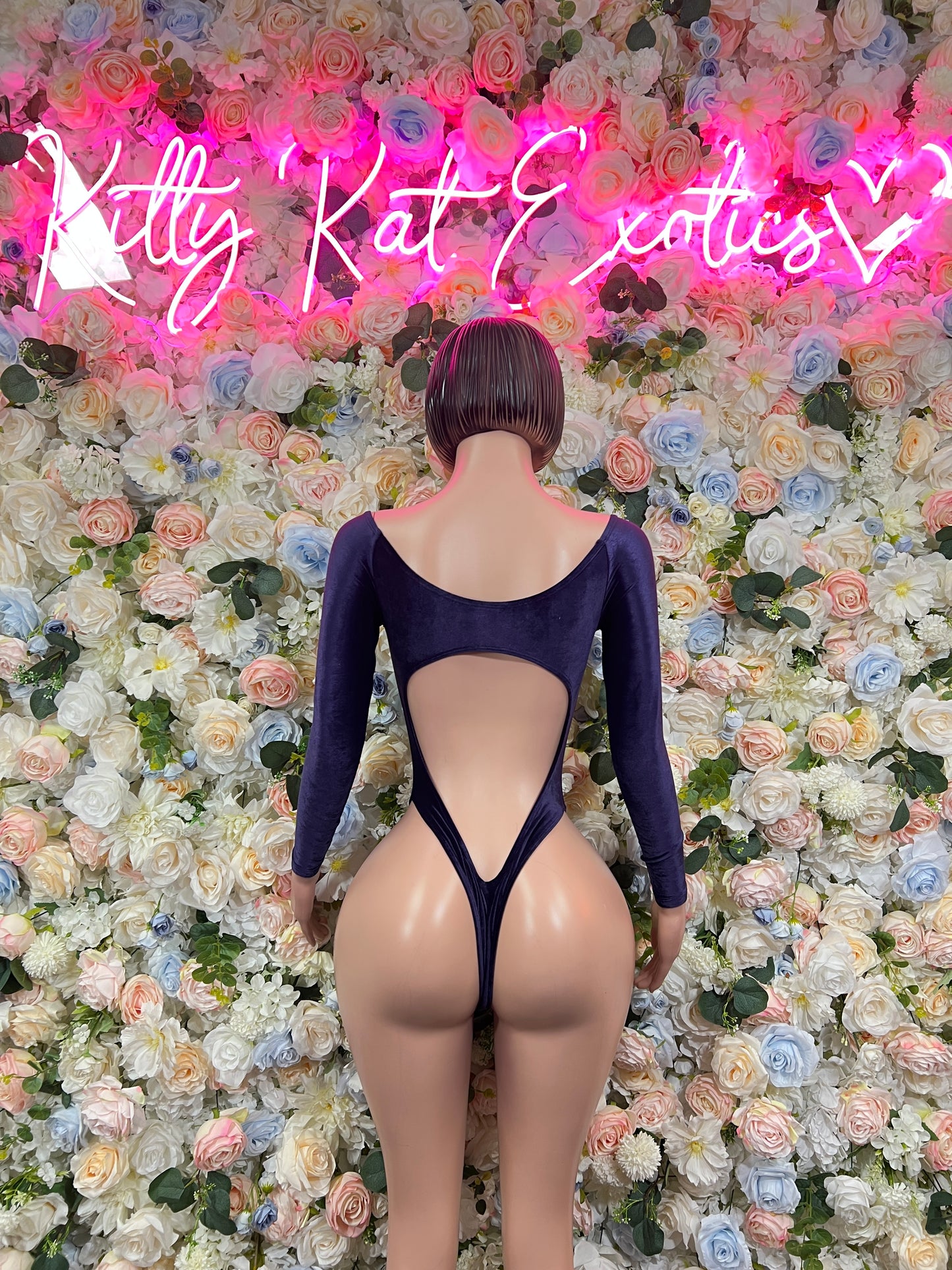 One-piece blue velvet bodysuit with long sleeves, open back and V-shaped cutout