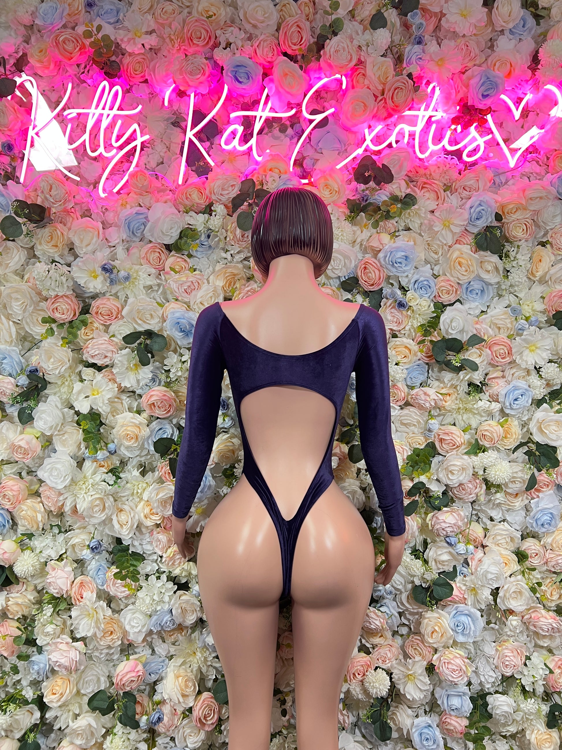 One-piece blue velvet bodysuit with long sleeves, open back and V-shaped cutout