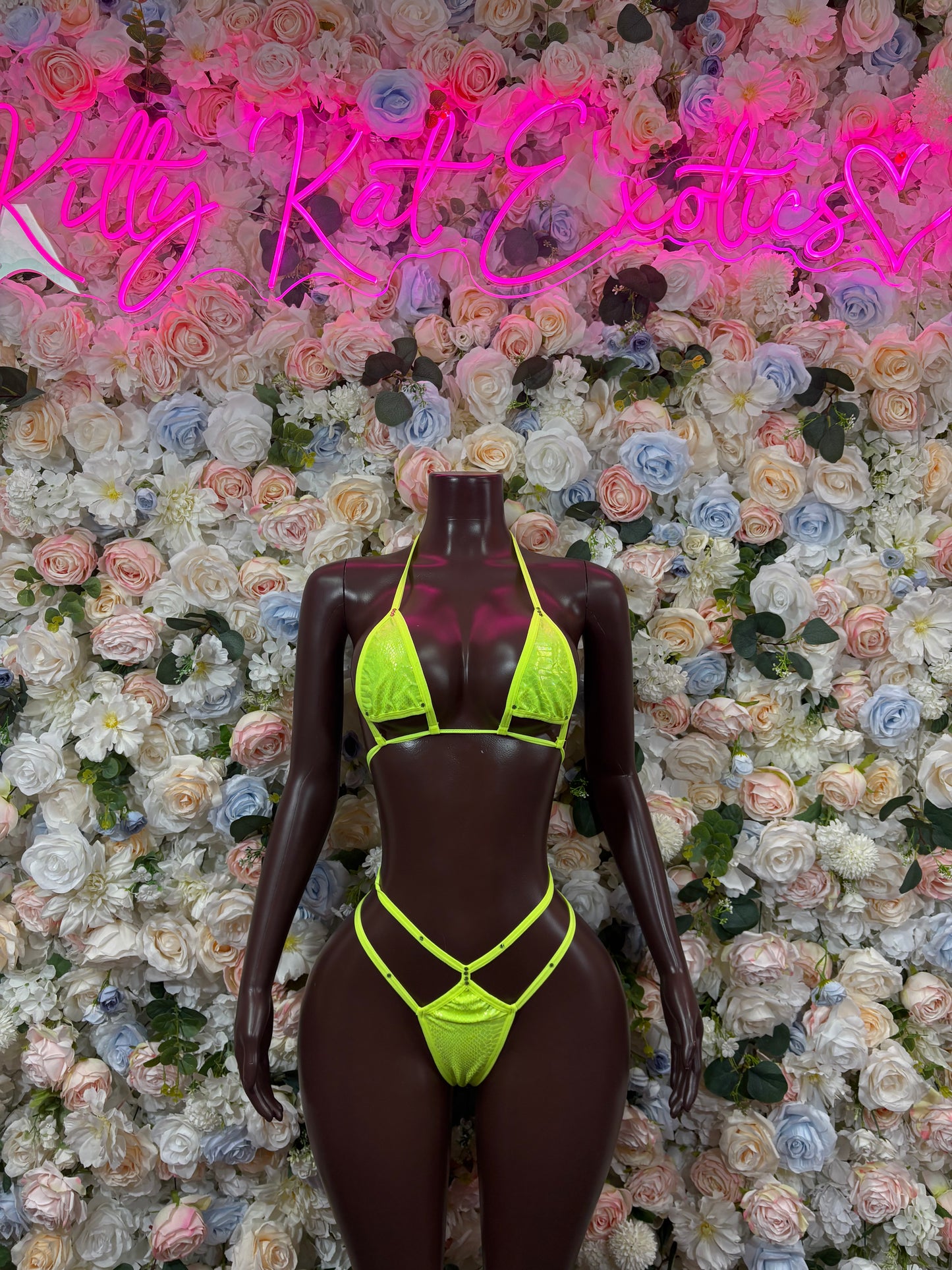 Neon green triangle bikini set on mannequin, neon straps and matching bottoms