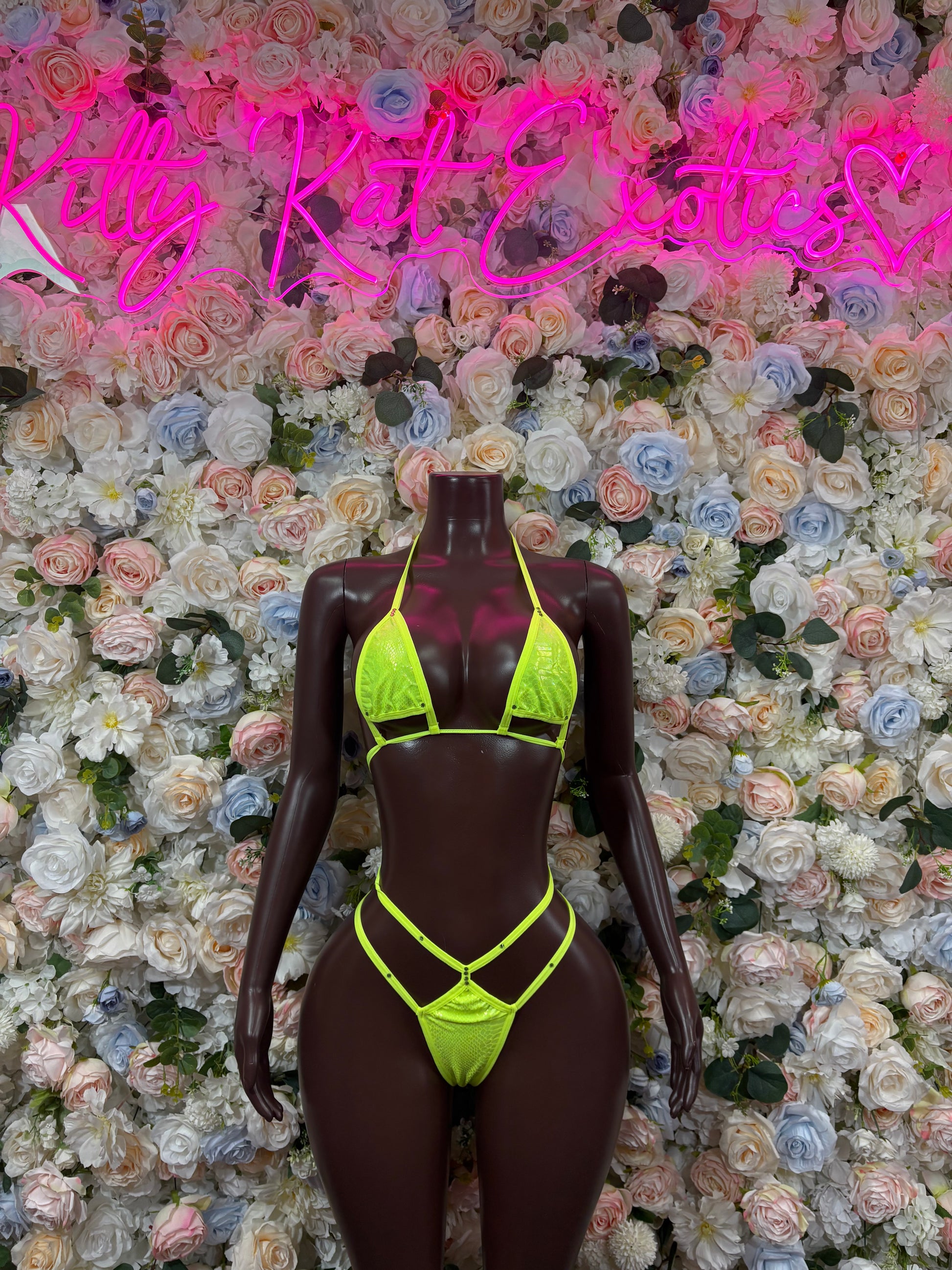 Neon green triangle bikini set on mannequin, neon straps and matching bottoms
