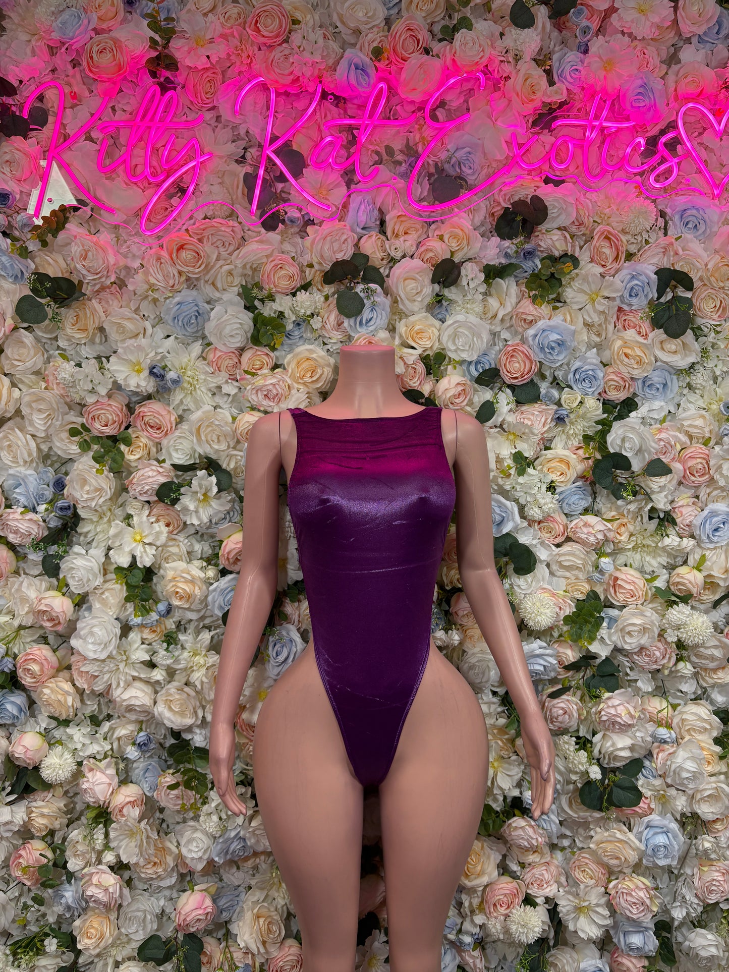 Purple velvet one-piece bodysuit with scoop front and high-cut leg