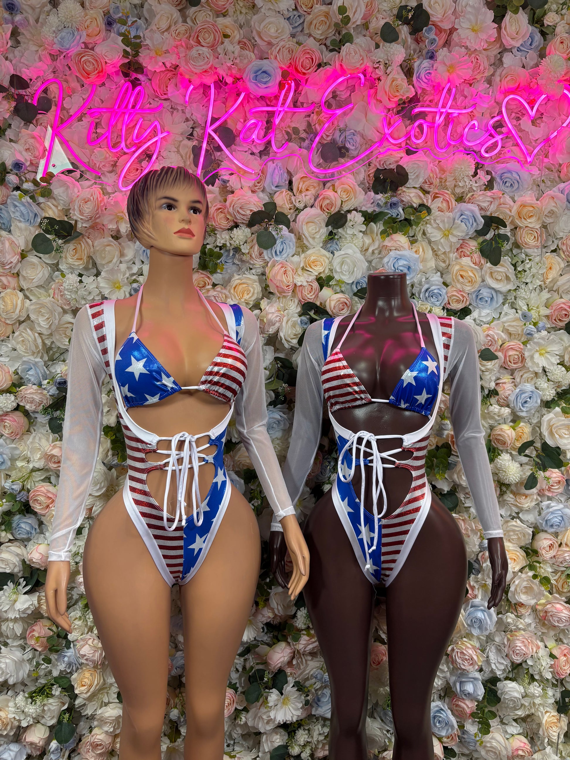 US flag bodysuit on mannequin: long sleeves, star-and-stripe triangle top and lace-up detail