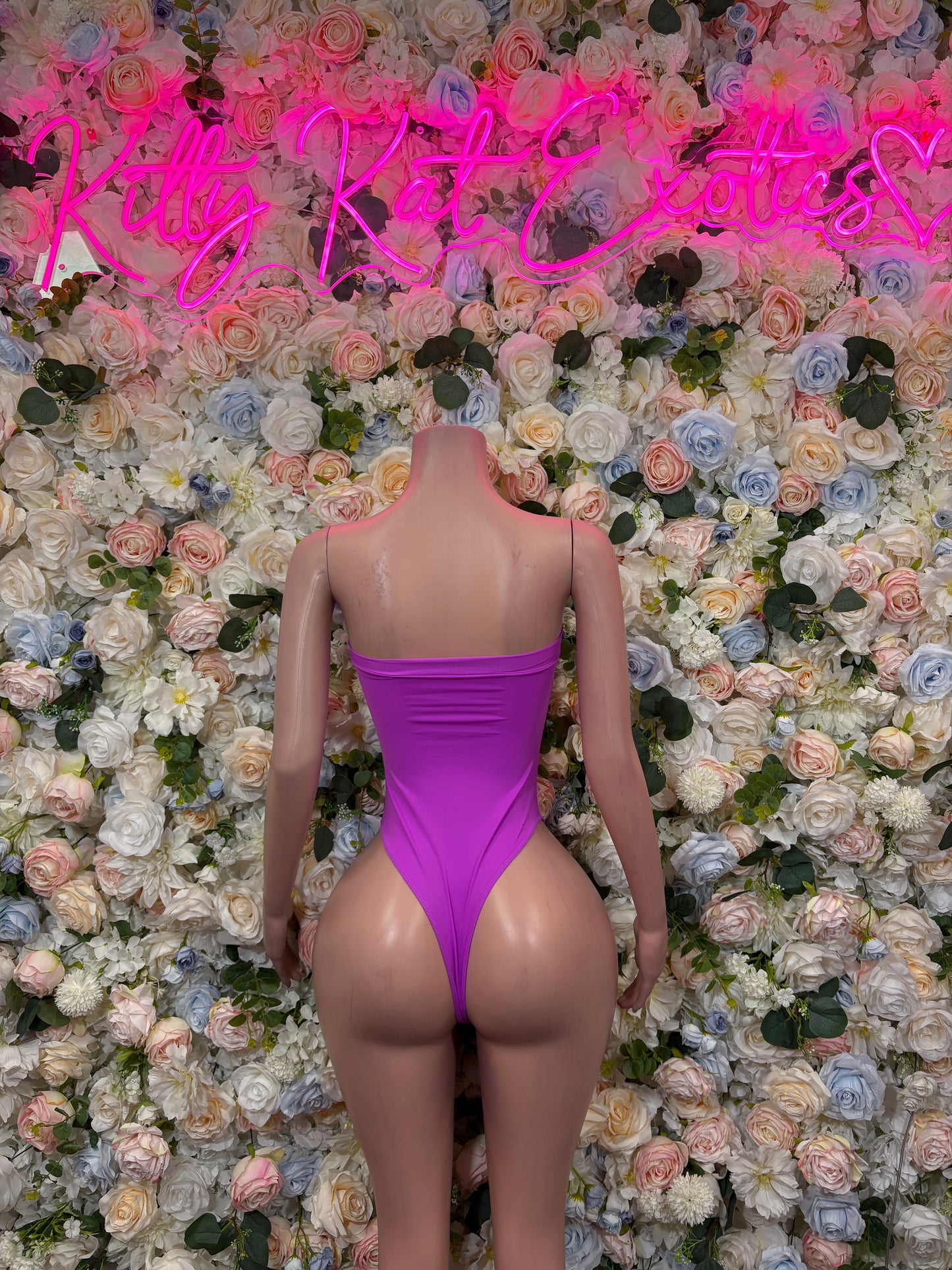 Purple one-piece rave outfit with strapless back and high-cut legs