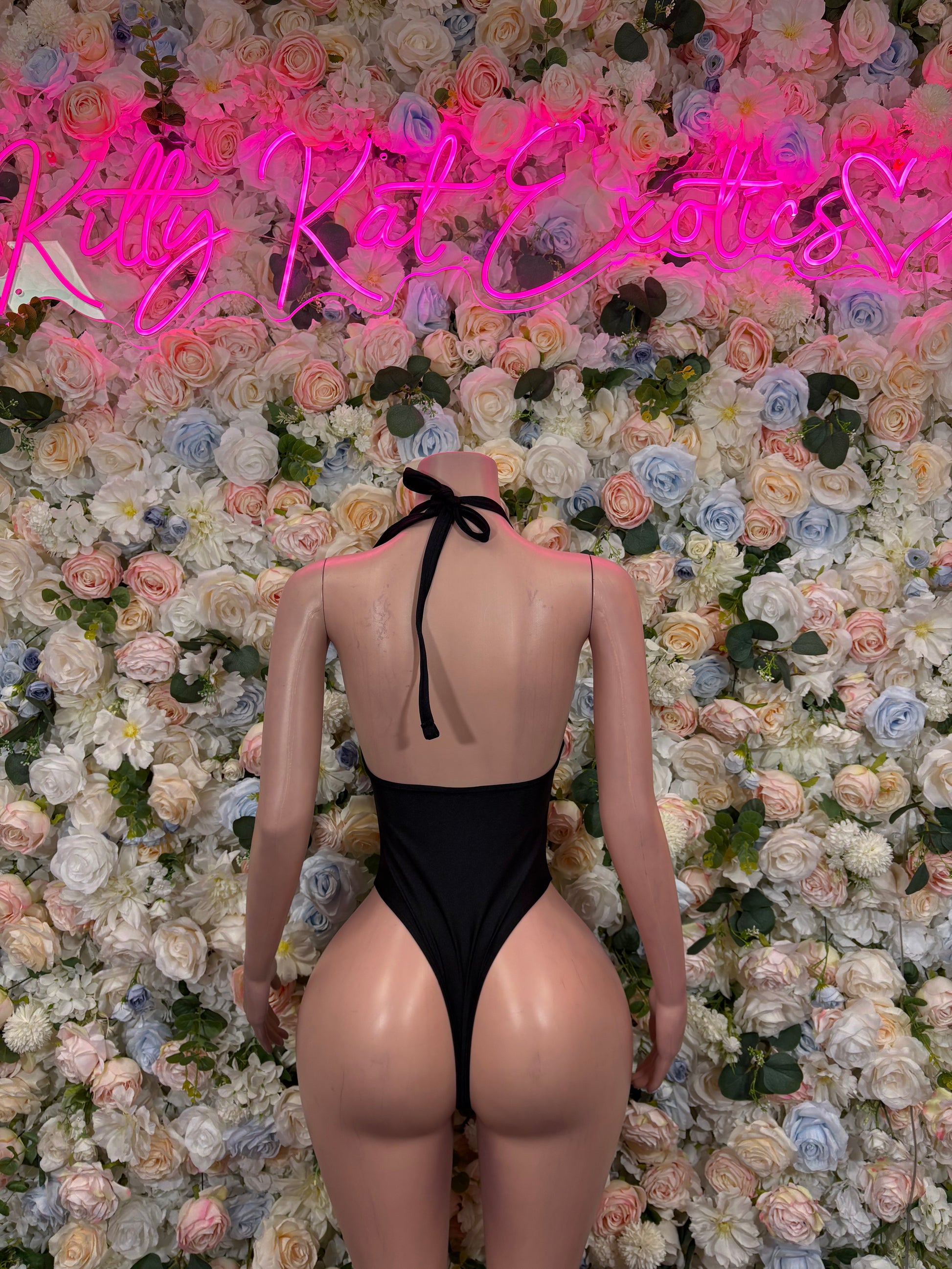 Black backless one-piece bodysuit with halter tie, lace front and open back