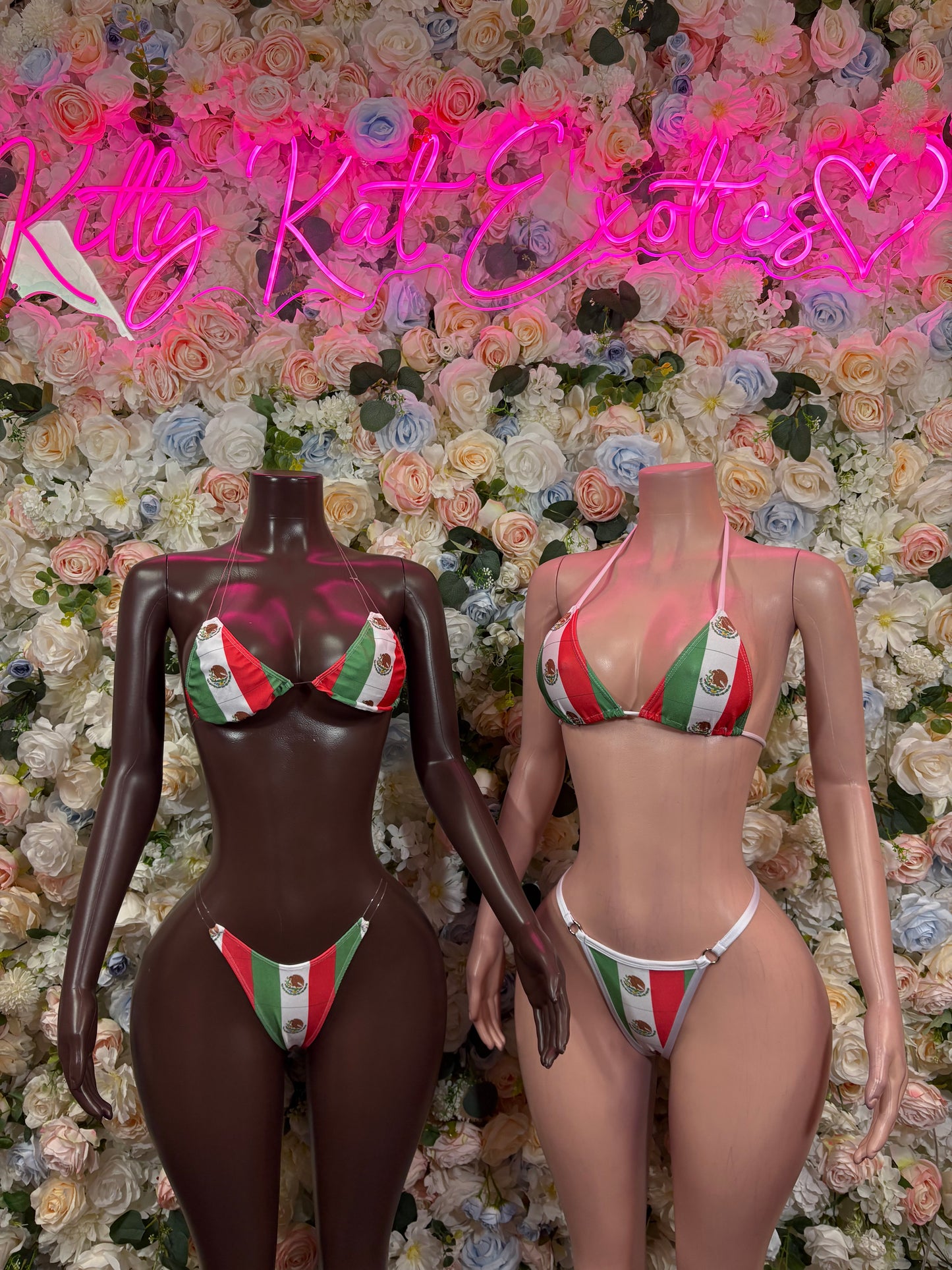 Two Mexican flag bikini bodysuits on mannequins, red, green, white triangle tops
