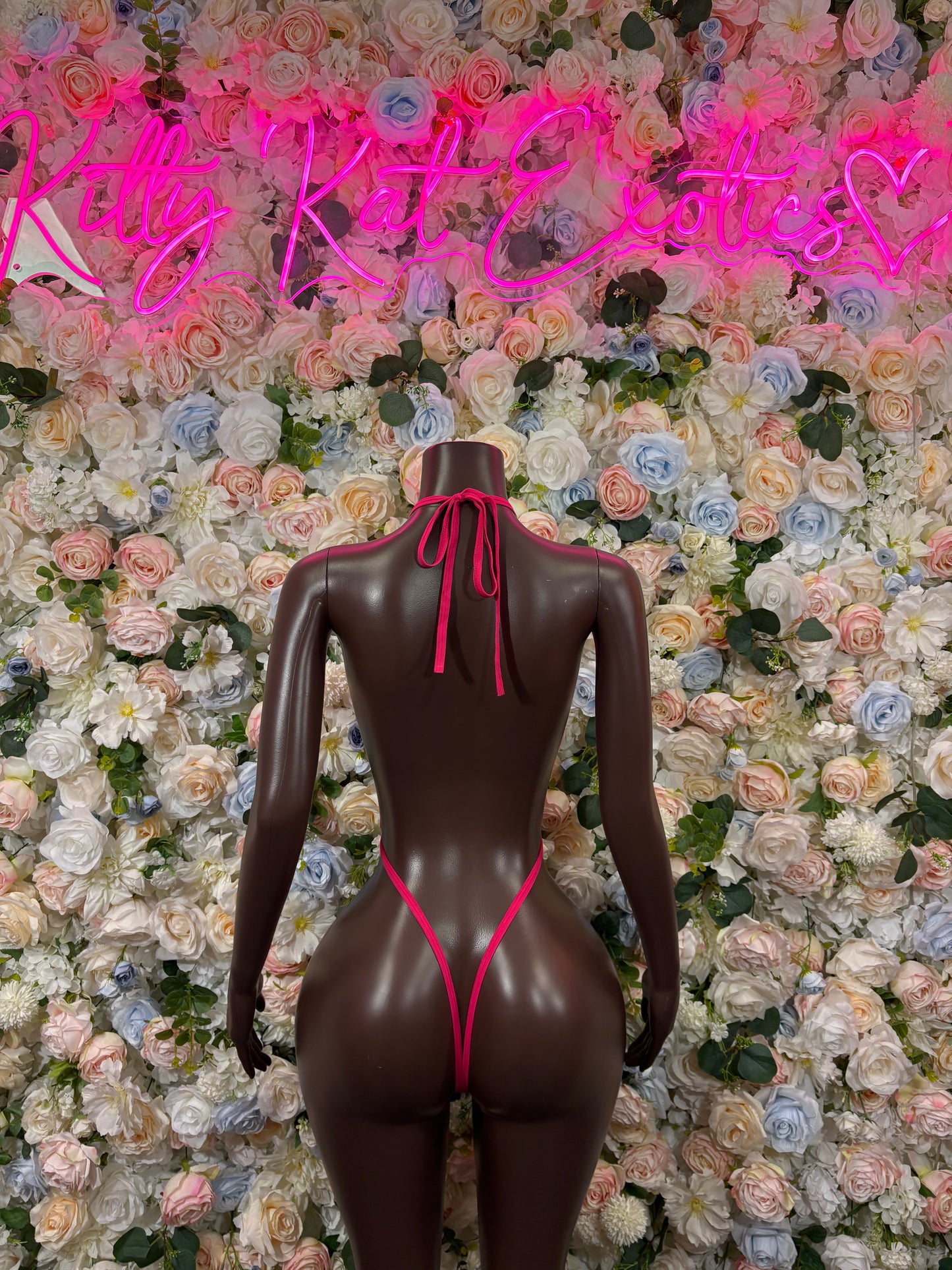 Pink mesh one-piece bodysuit with open back and lace-up strap ties