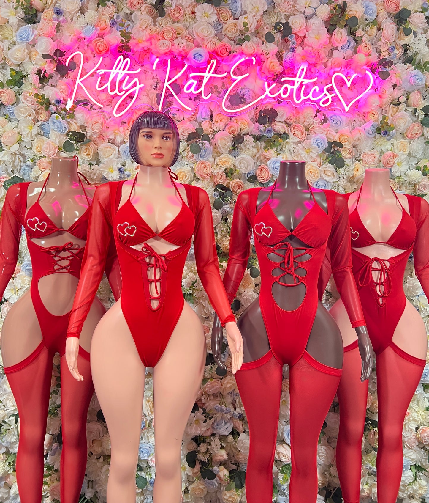Red heart bodysuits on mannequins, long sleeves with lace-up front and cutouts