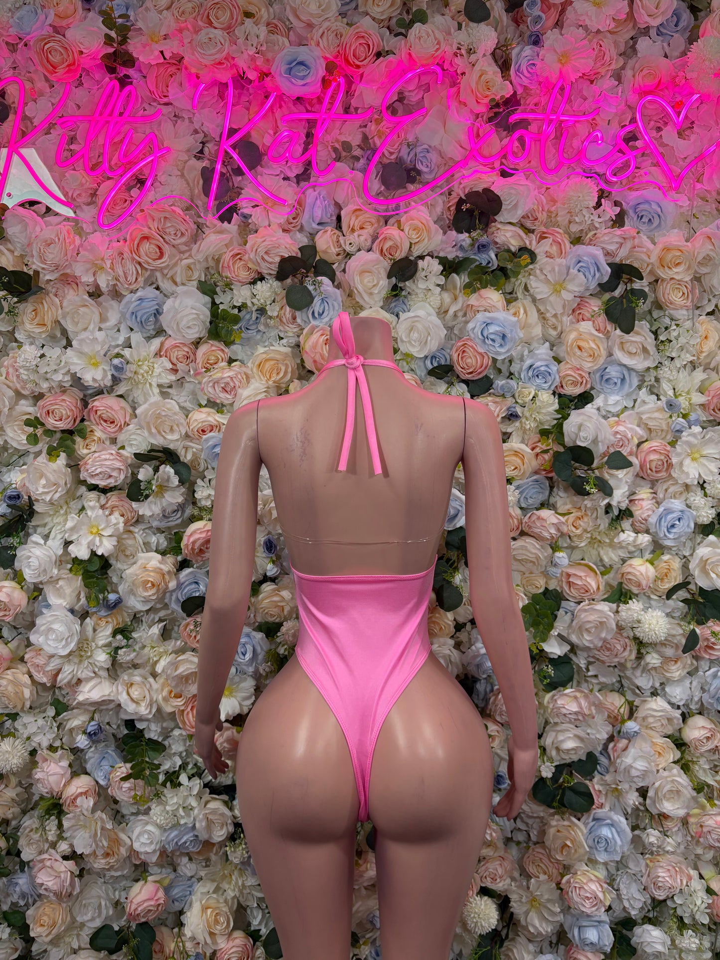 Pink open-back halter bodysuit with back tie and high-cut leg