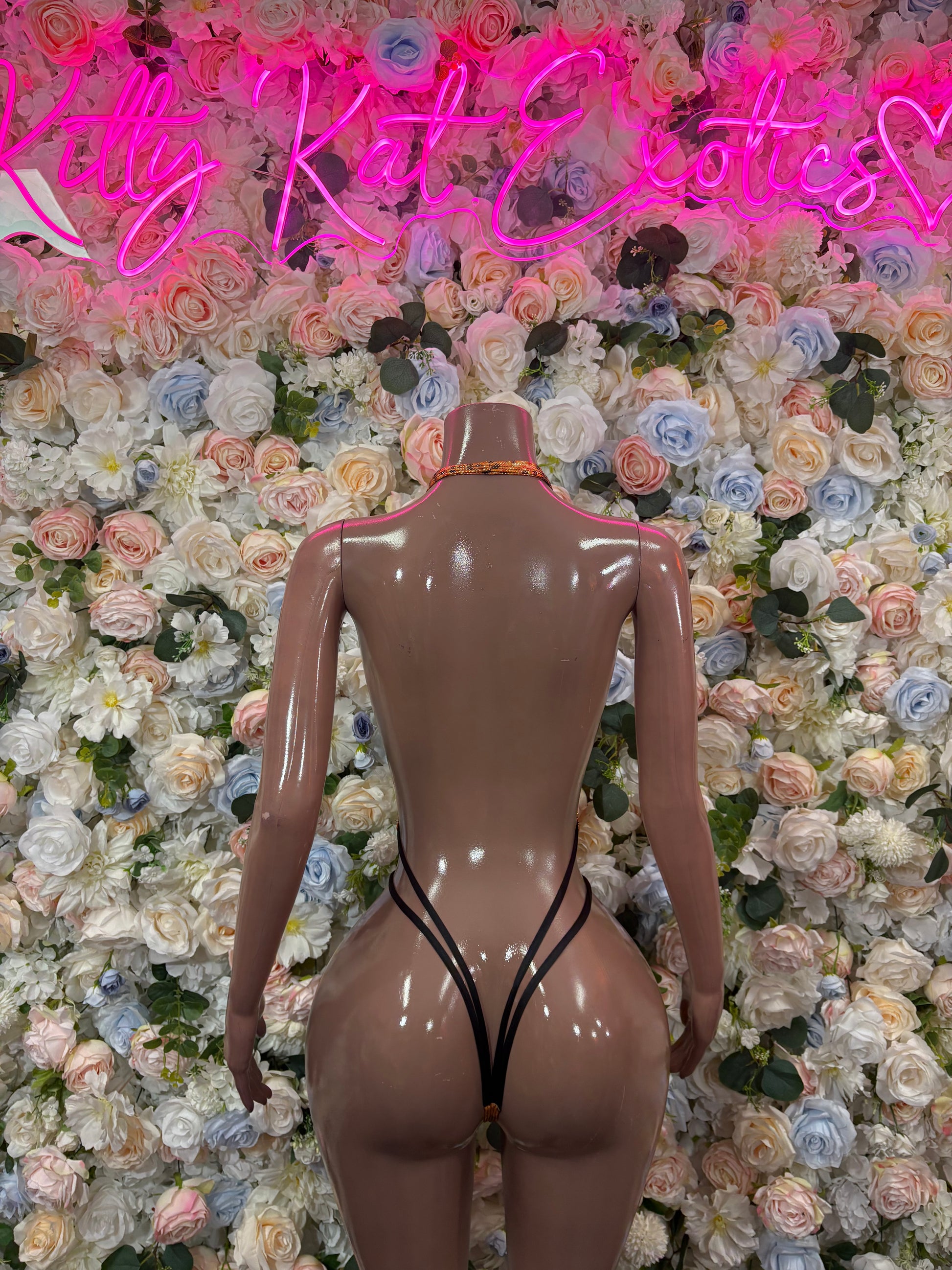 Orange snake-print one-piece bodysuit with open back and thong bottom
